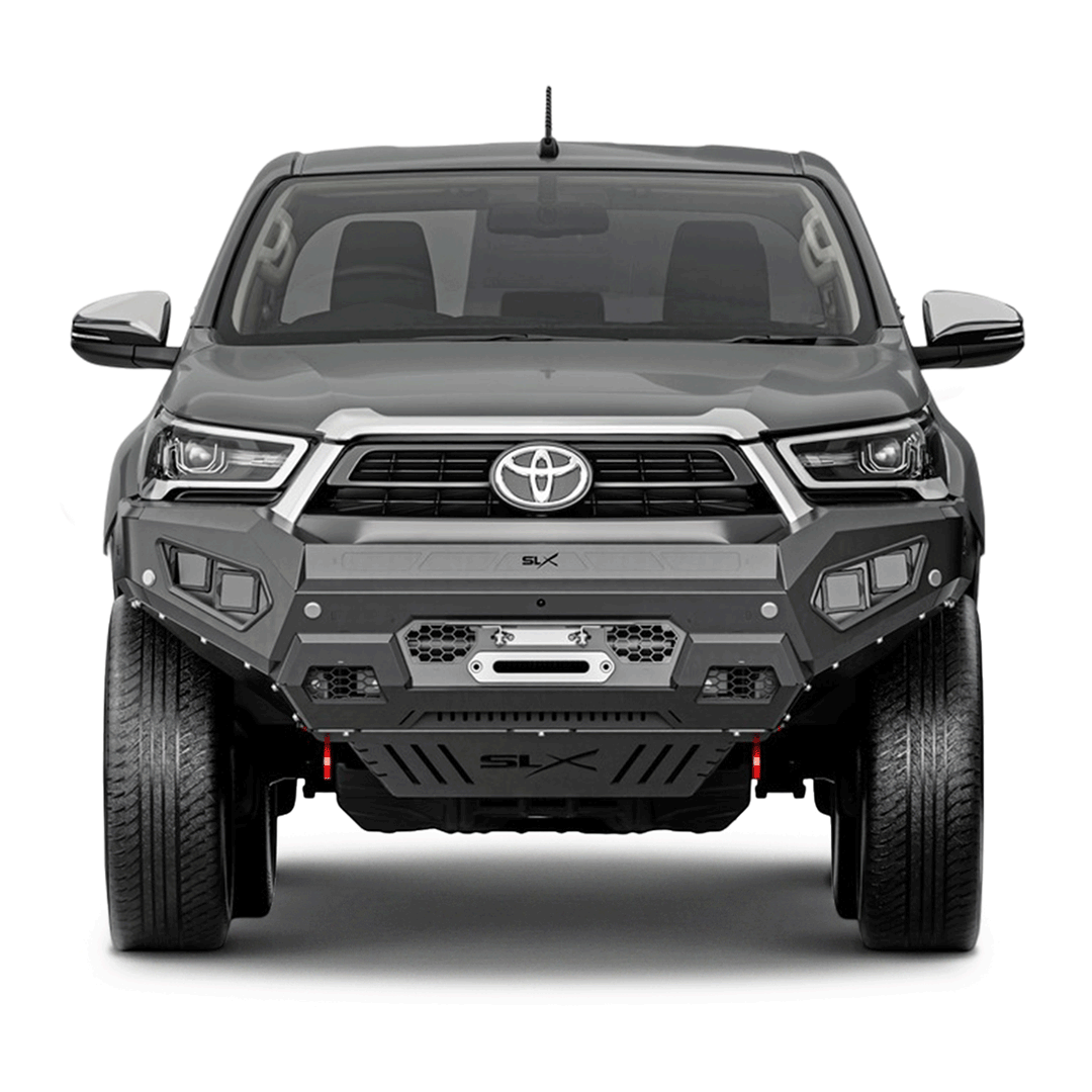 Front view of a gray Toyota pickup truck with a reinforced front bumper and large tires.