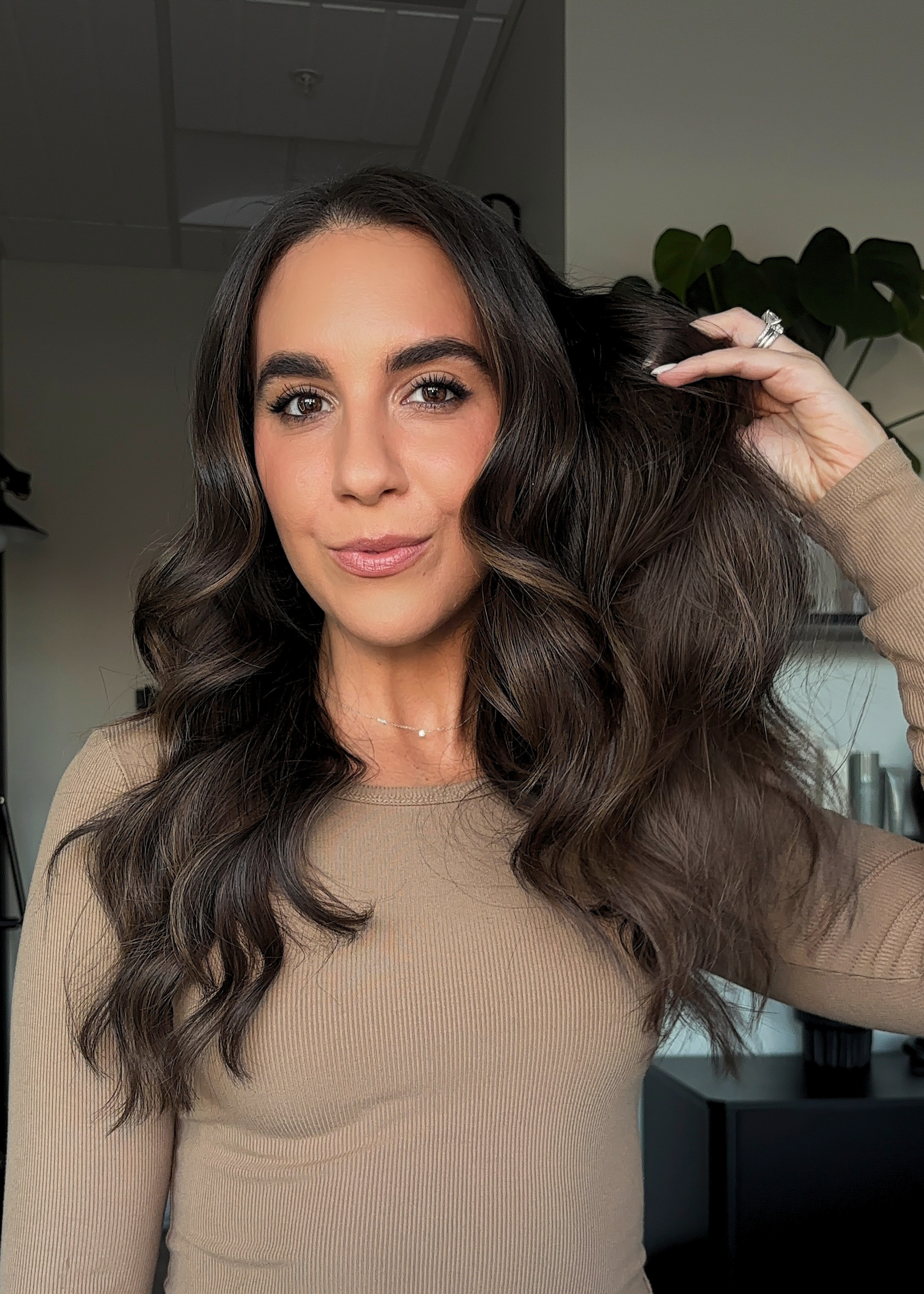 Brunette wavy hair with dimension and soft highlights