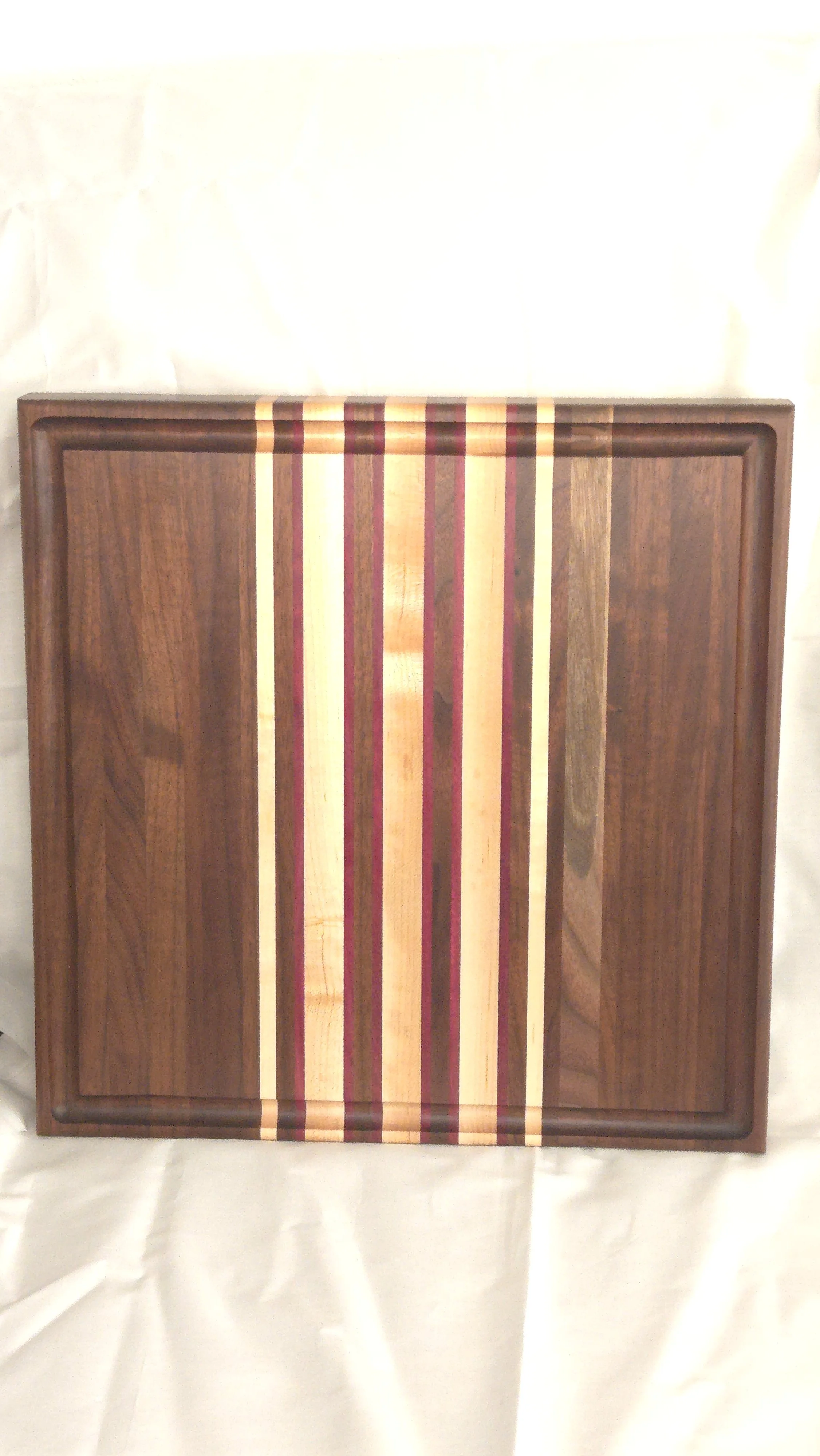 Reversible strip pattern cutting board