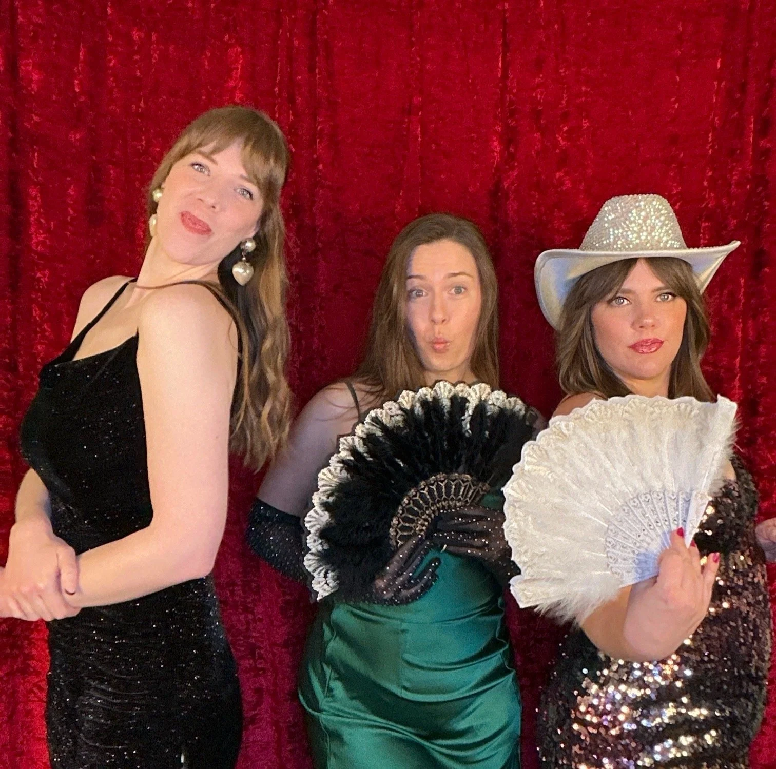 Wedding guests enjoying a Nashville photo booth with red backdrop and props, capturing fun moments at a luxury wedding reception