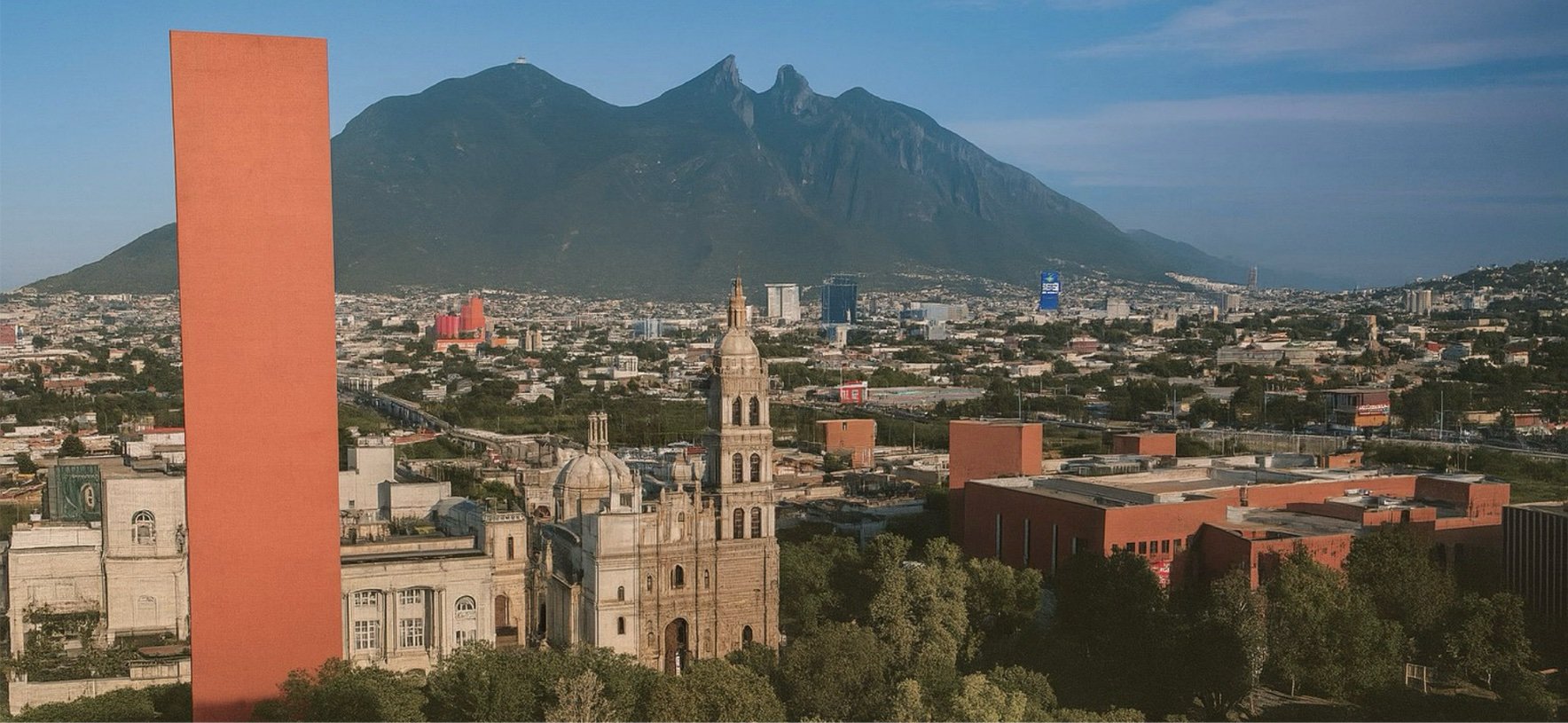 Cityscape of Monterrey, Mexico, with a historic church in the foreground, modern buildings, and the Sierra Madre Oriental mountains in the background.
