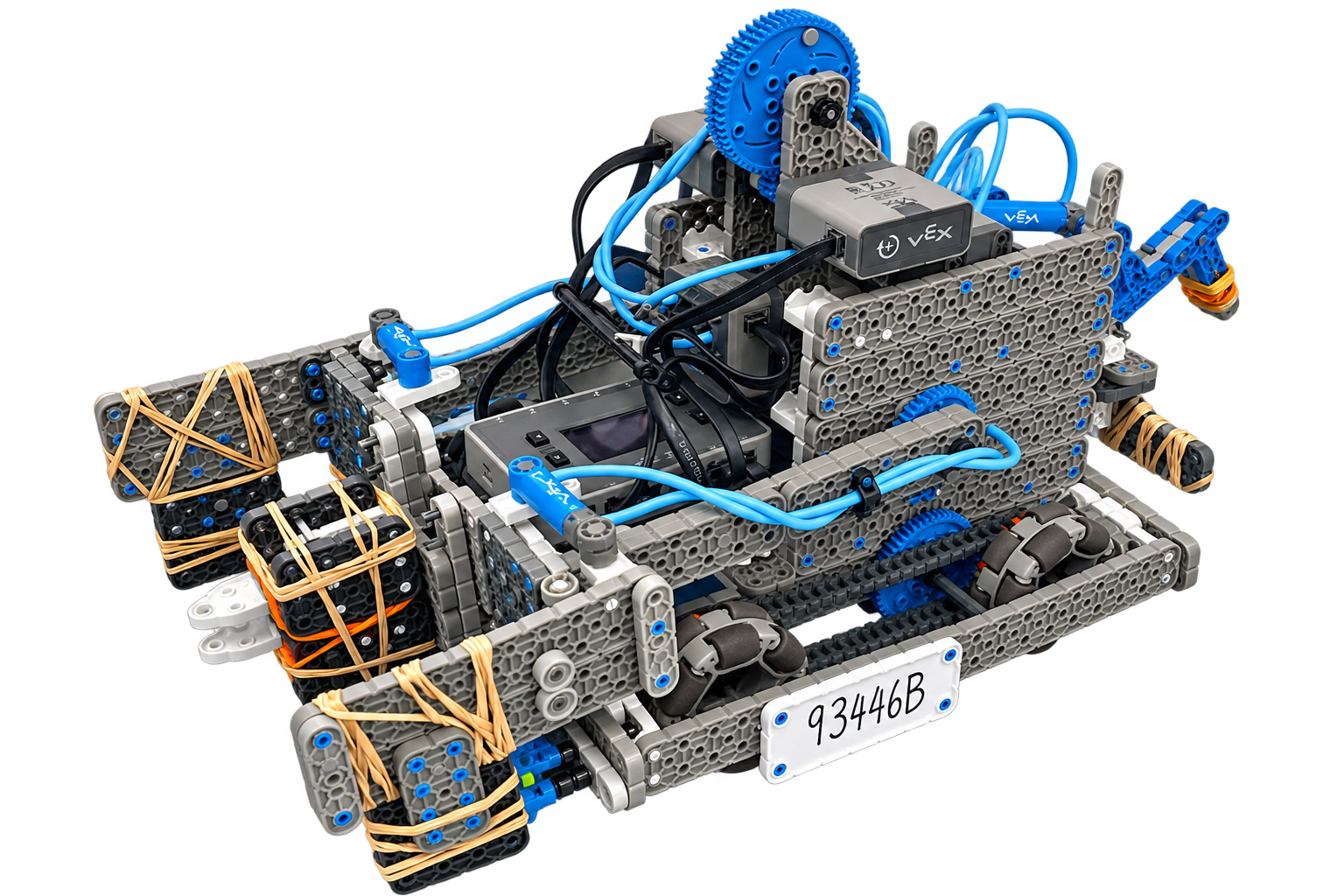 A robotic vehicle constructed from gray, blue, and black LEGO pieces with wires, sensors, and gears, featuring a white license plate with the number 93446B.