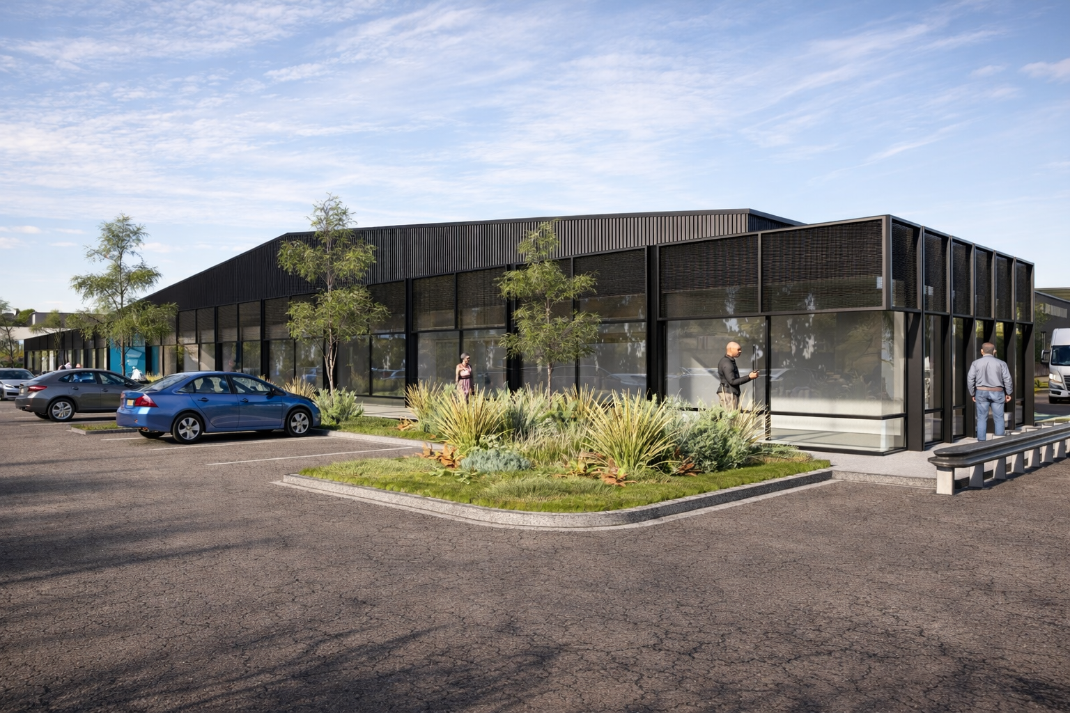 Modern commercial building with black exterior, large glass windows, parking lot with cars, and people walking outside on a sunny day with a blue sky.