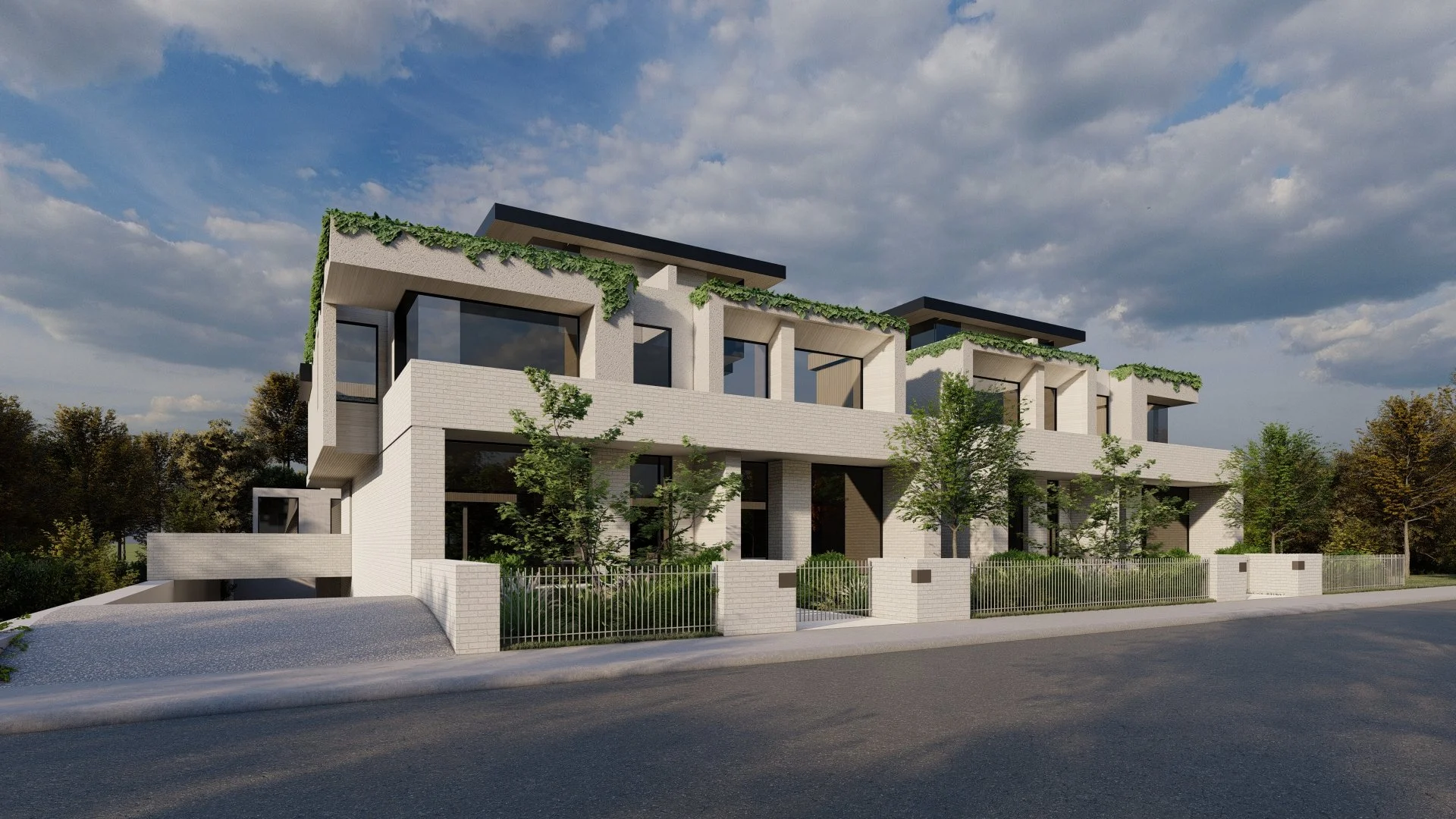 Modern multi-story residential building with white brick facade and large glass windows, surrounded by trees and a black metal fence, under a partly cloudy sky.