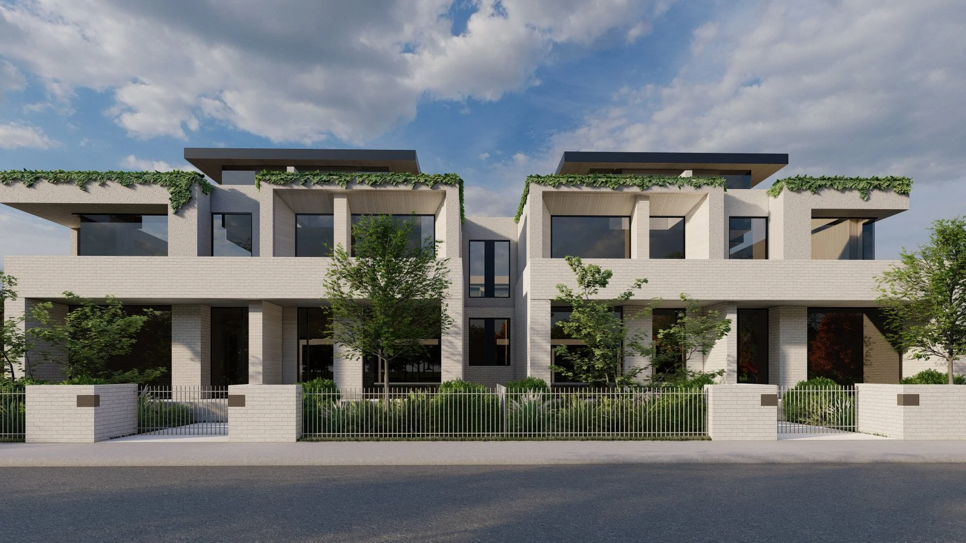 Modern multi-story residential building with white exterior, large windows, greenery on balconies and rooftop, and a metal fence in front.