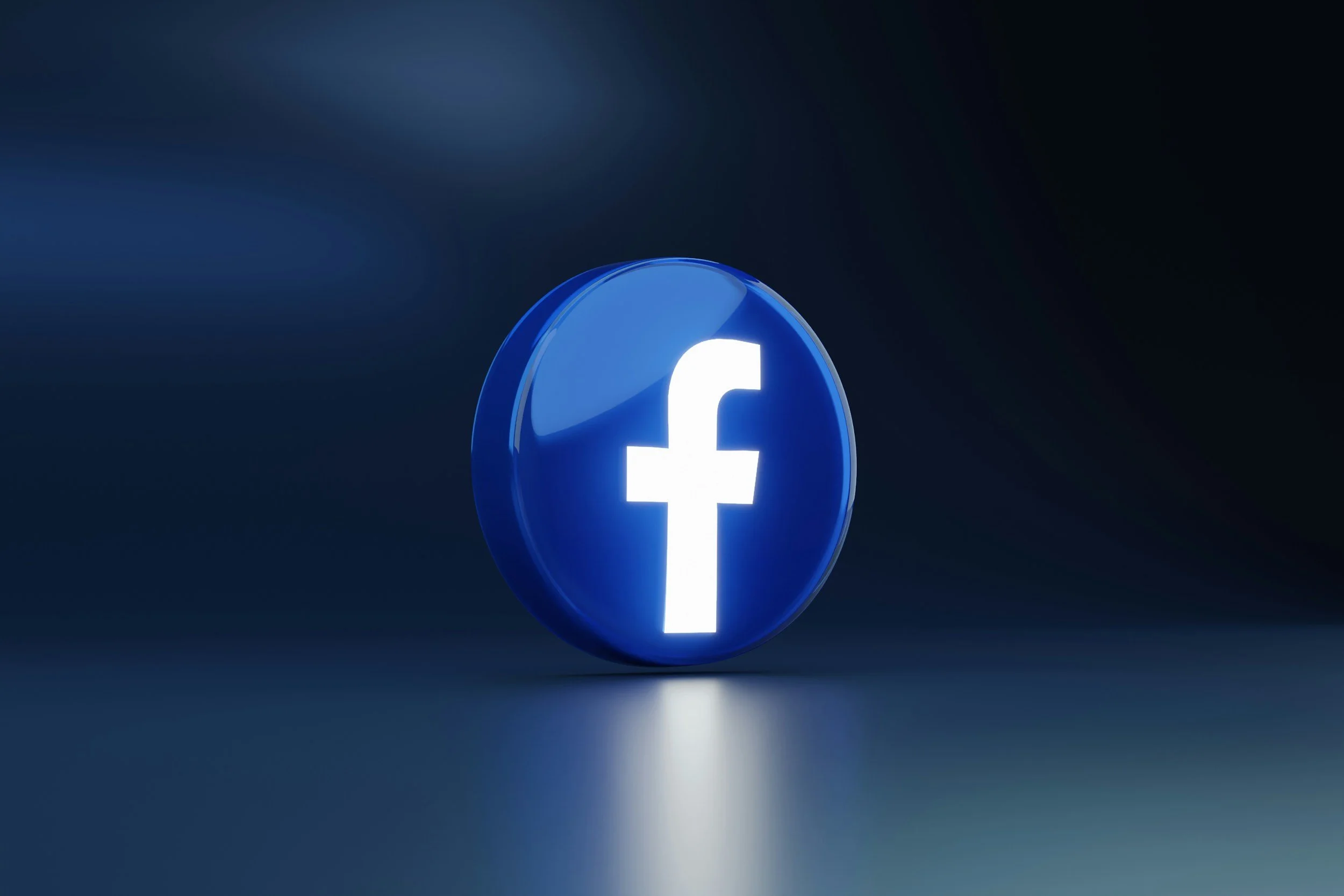 Blue circular Facebook logo with a white lowercase 'f' on a dark background.