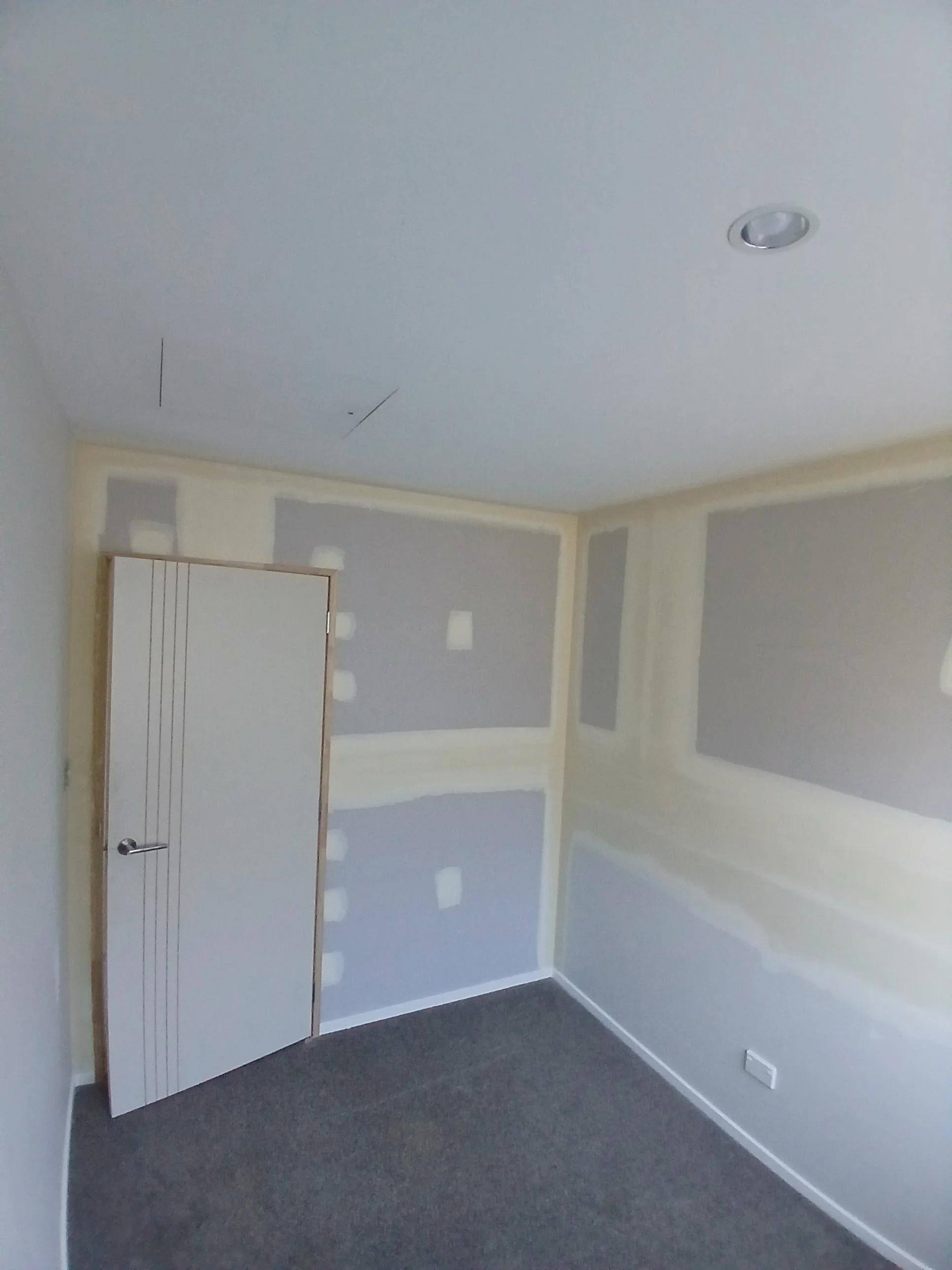 Room interior with new door &amp; hardware installed.