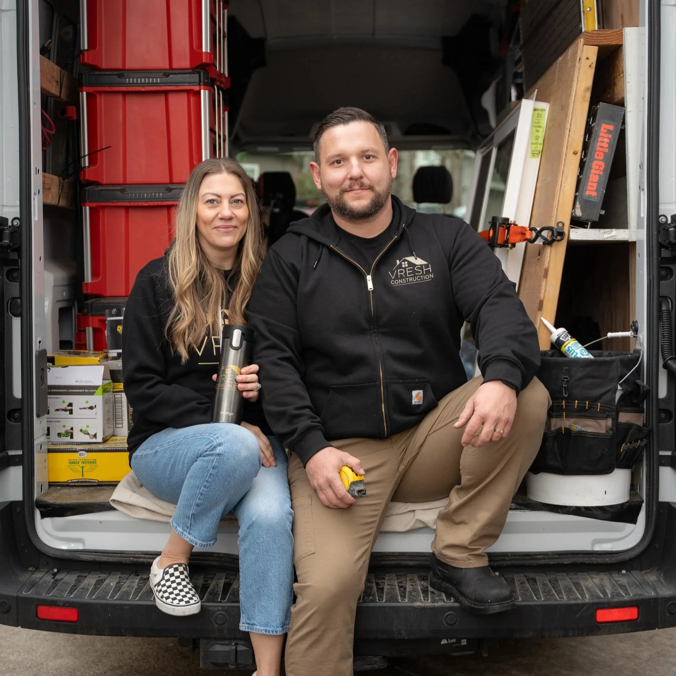 Two contractors sitting in work van with tools, symbolizing deck project planning and how different scopes affect pricing and construction costs.