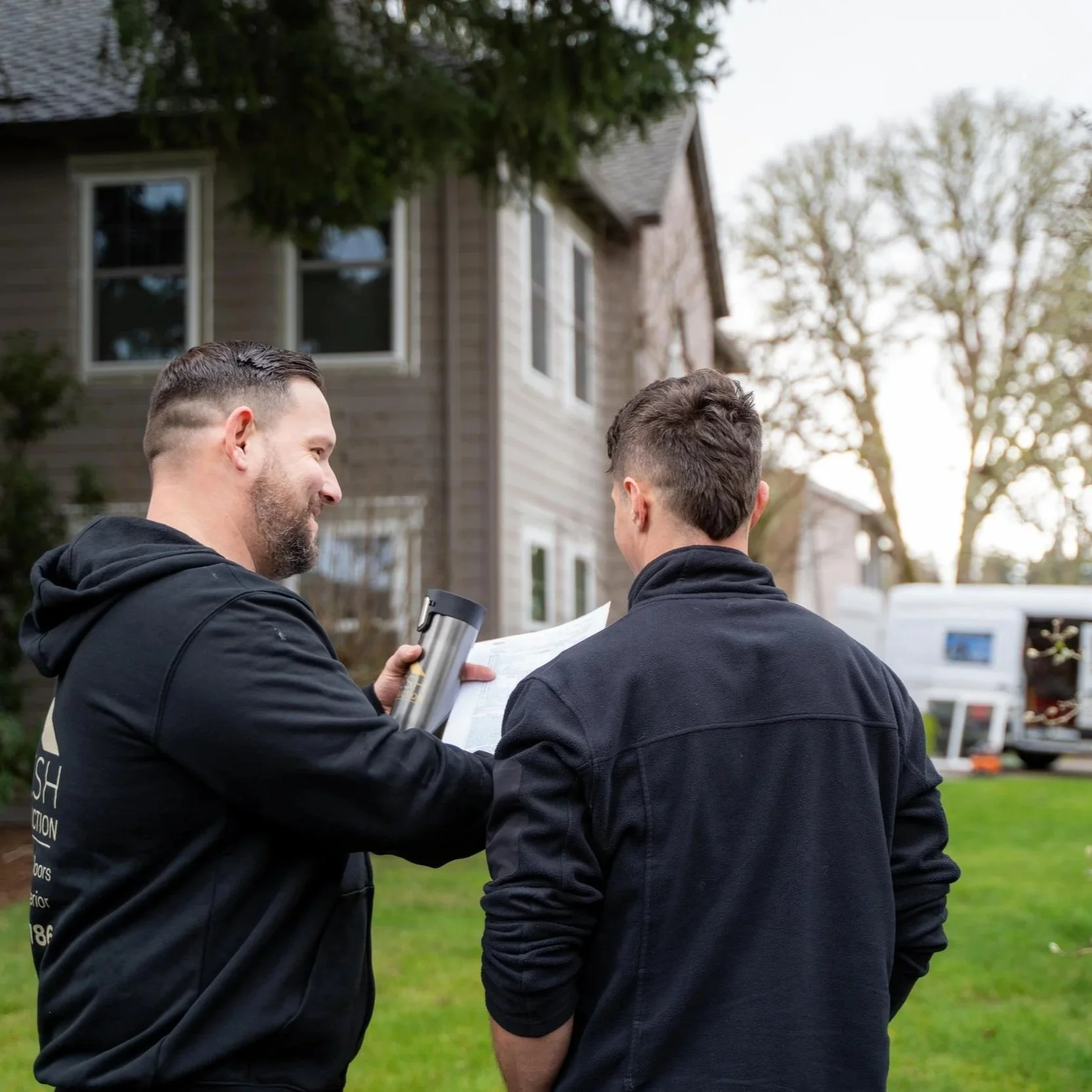 Contractor discussing siding with homeowner, showing importance of maintaining fiber cement siding through caulking, cleaning, and inspection to prevent hidden moisture damage.