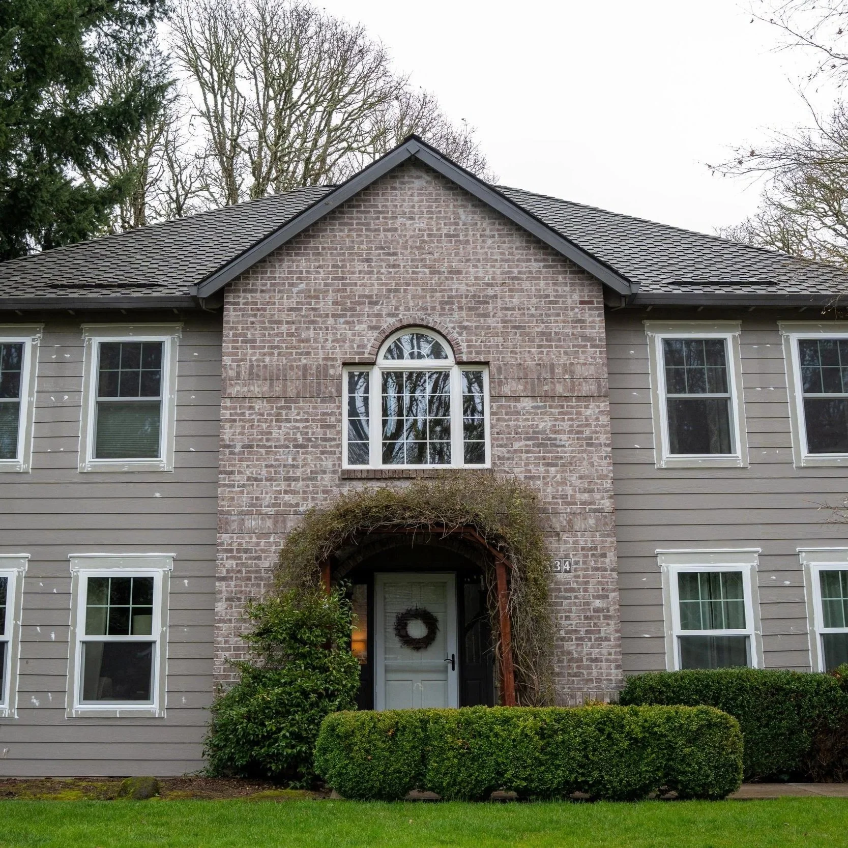 Two-story Portland home featuring patio door access, showcasing weather-resistant exterior design suitable for rainy Pacific Northwest conditions and remodeling projects.