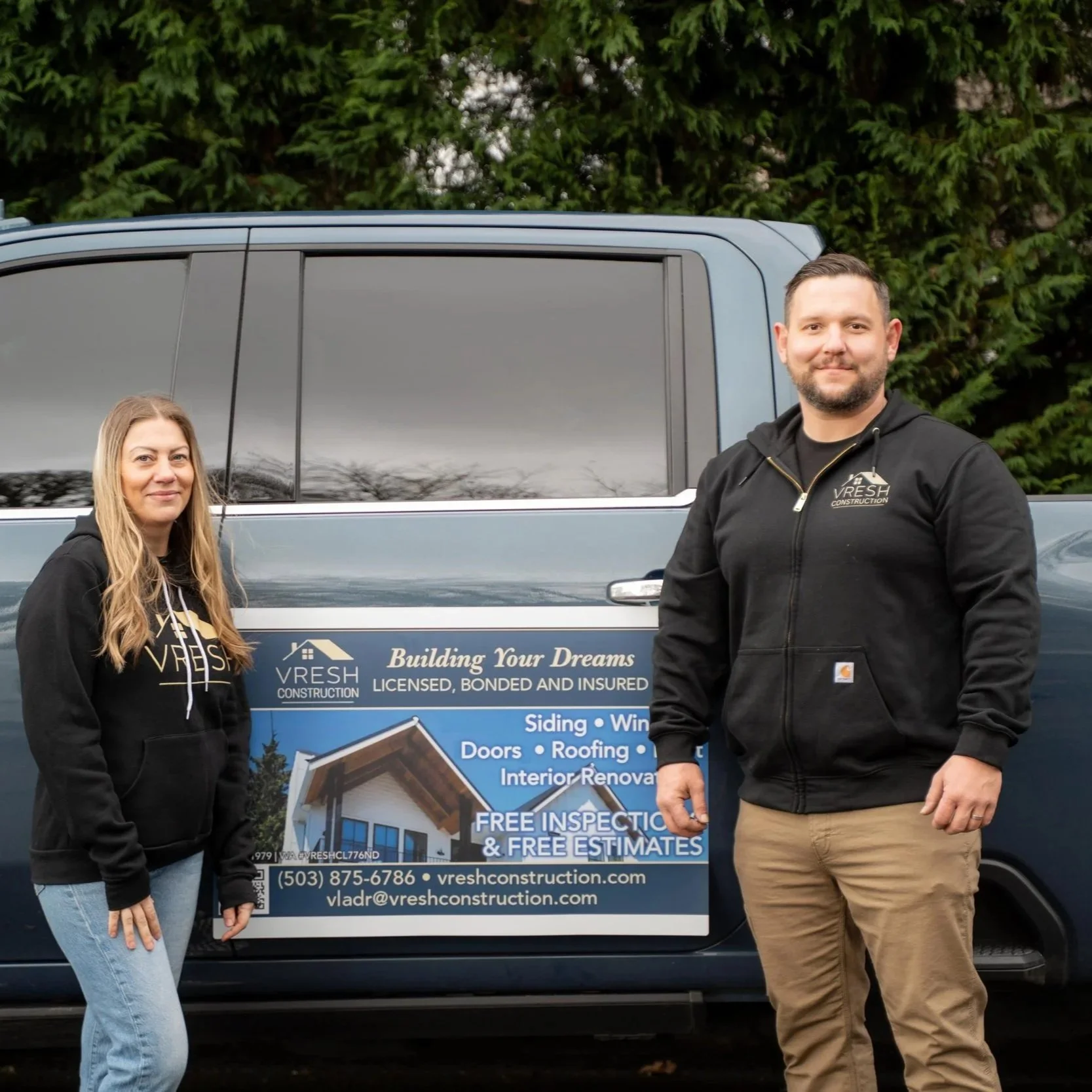 Portland contractors standing beside company vehicle, representing dry rot inspections, moisture damage detection, and structural repair services for local homes.