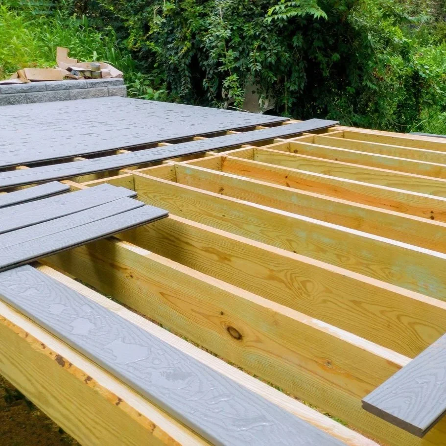 Wood patio cover framing with partially installed boards showing structural spacing, support beams, and ongoing repair work on outdoor covering.