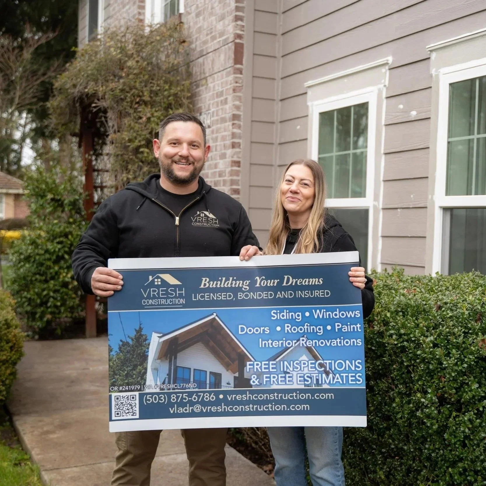 Construction team standing outside residential property promoting egress window installation services for Portland basement renovations and code compliance upgrades.