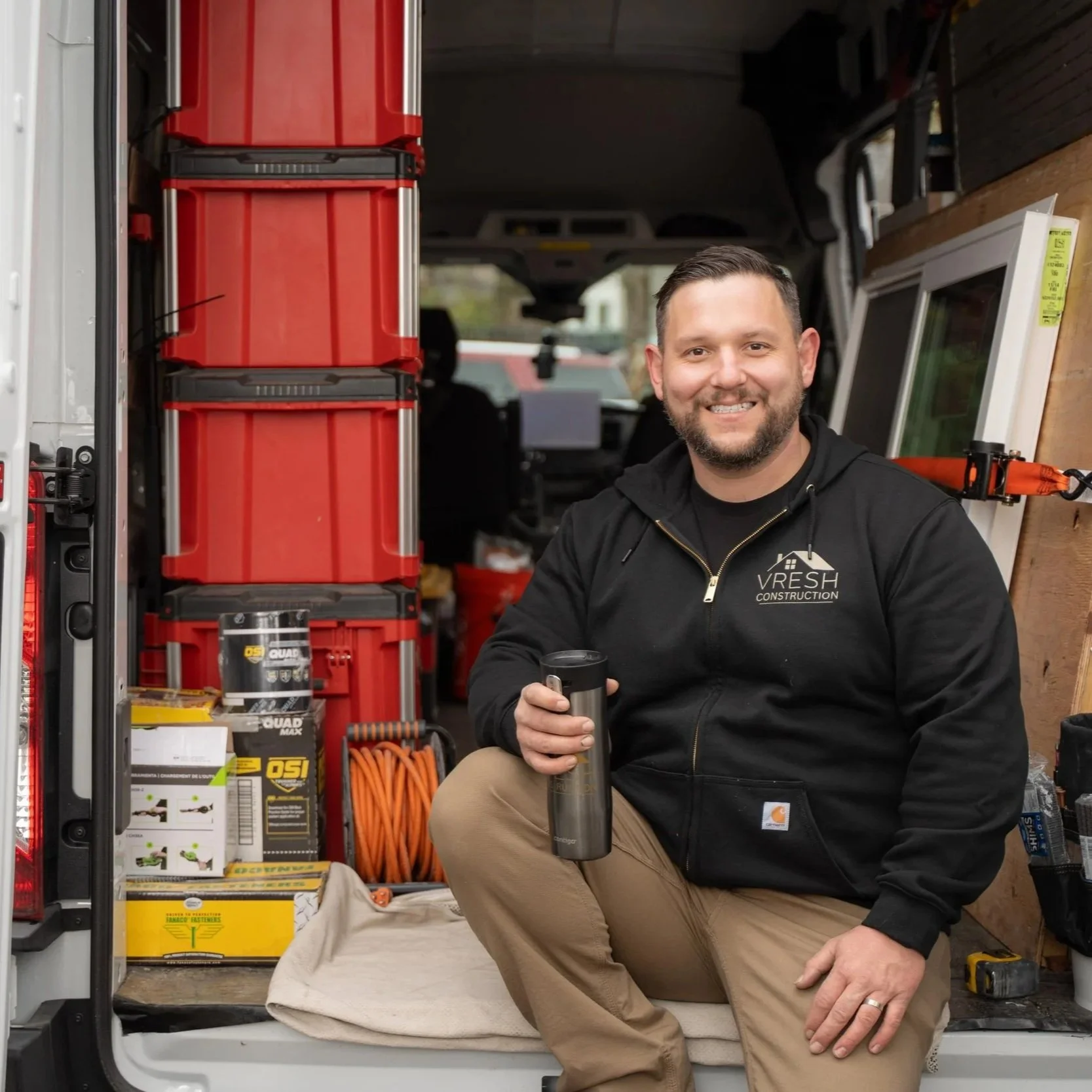 Contractor sitting in work van with tools, representing EPA-certified renovation work required for safely handling lead paint in pre-1978 homes.