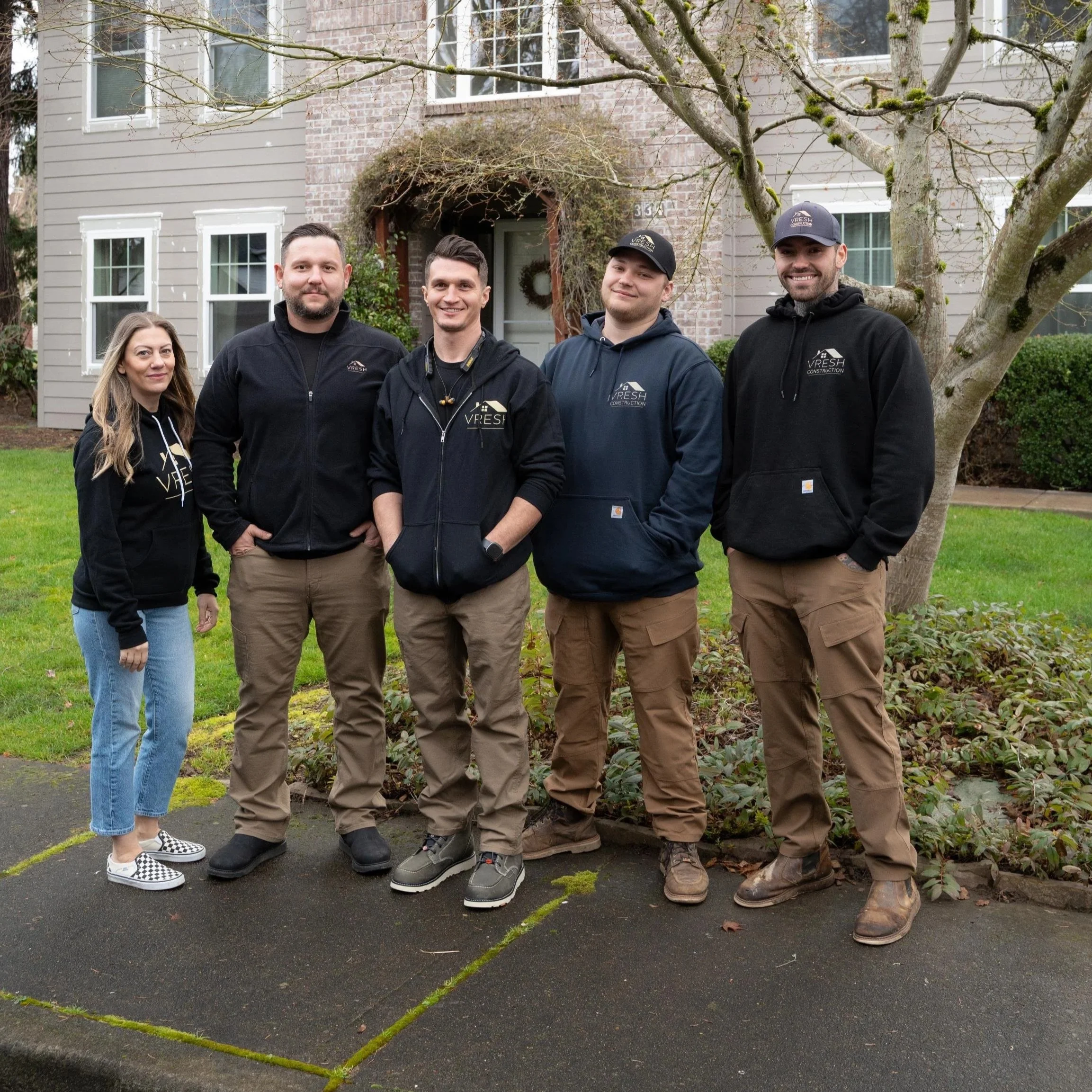 Group of contractors standing with homeowners during Portland renovation consultation focused on licensing, written estimates, and contractor hiring safety.