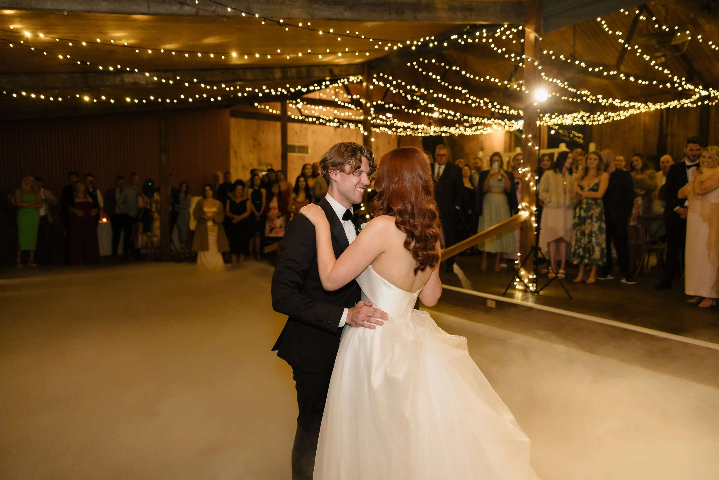 Bride and groom first dance under fairy lights at Glen Ewin Estate reception