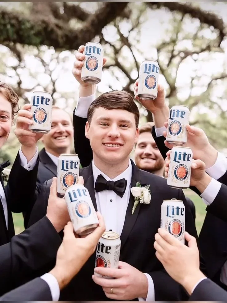 Funny wedding party photos, playful groomsmen toasting, captured by Magnolia, Texas Wedding photographer.