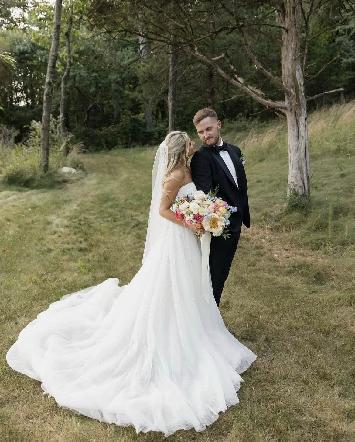 Outdoor wedding photos, bride and groom pictured happily married, image captured by Wedding Photographer in Conroe, Texas.