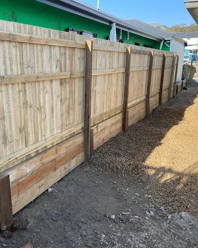 New wooden privacy fence installed along a construction site.
