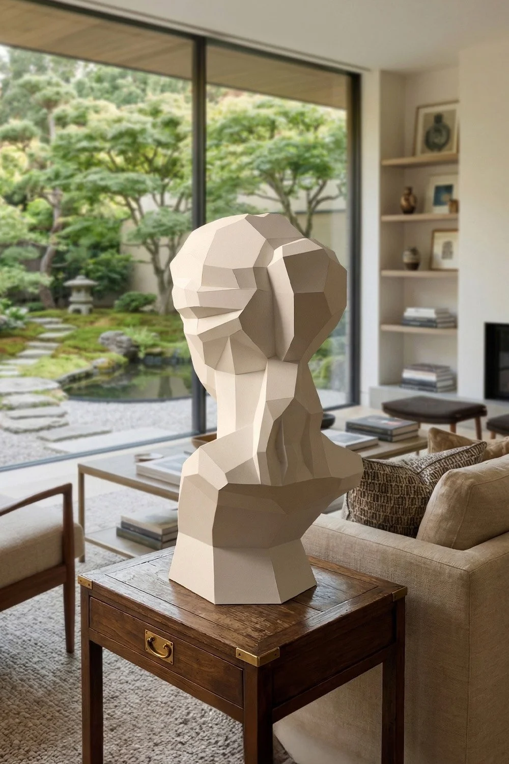 Rear view of LUMISCA Venus sculpture on a vintage wooden table, overlooking a Zen garden. The contrast between the geometric paper edges and the soft natural background.