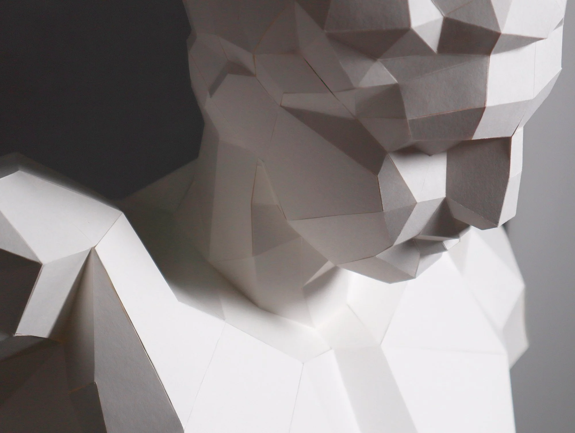 Extreme close-up of a LUMISCA Hermes sculpture detail. Highlighting the sharp edge where maximum darkness meets maximum light, the core aesthetic of Lumisca.