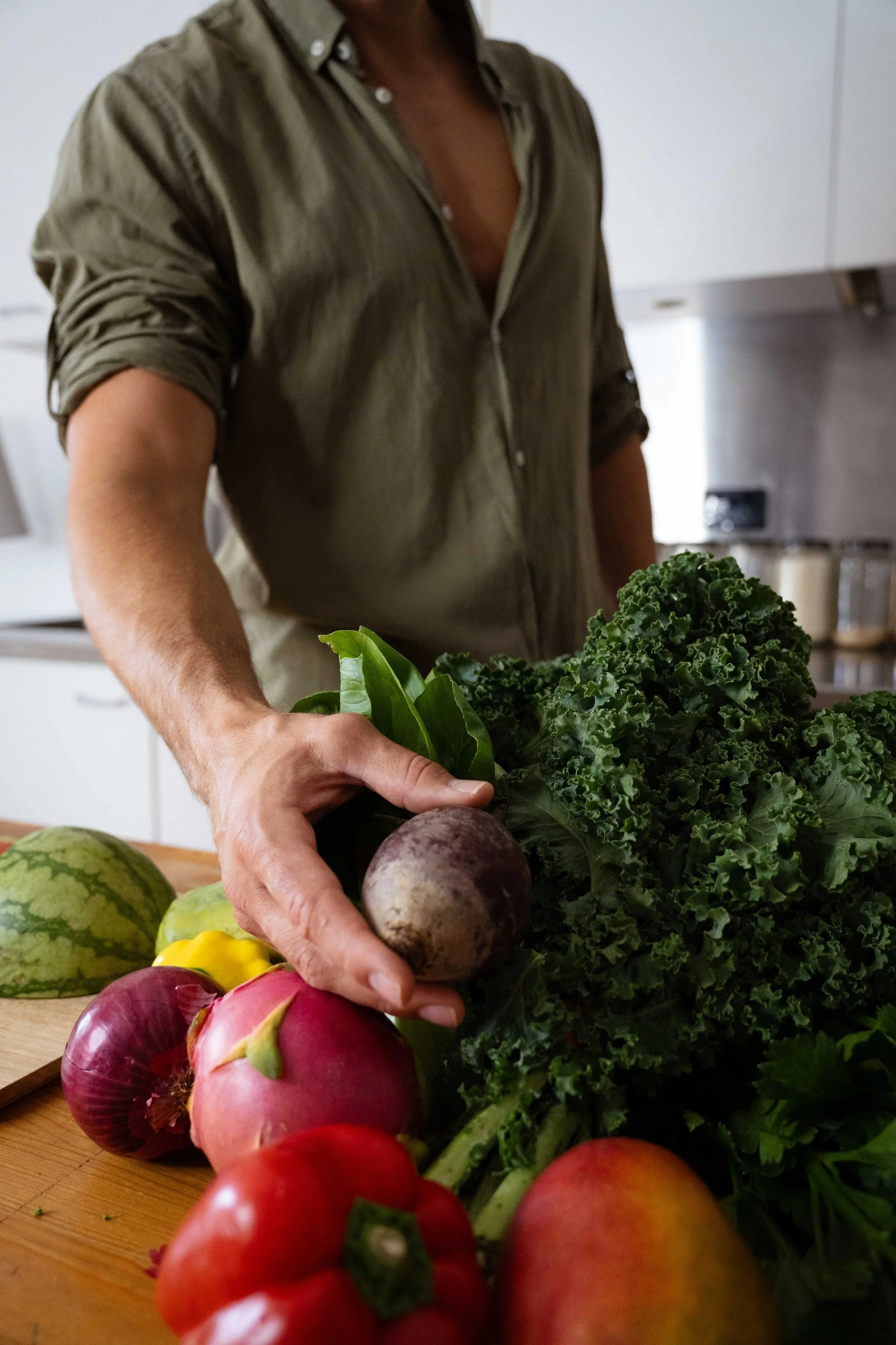 James Armstrong plant-based nutritionist preparing fresh greens kitchen