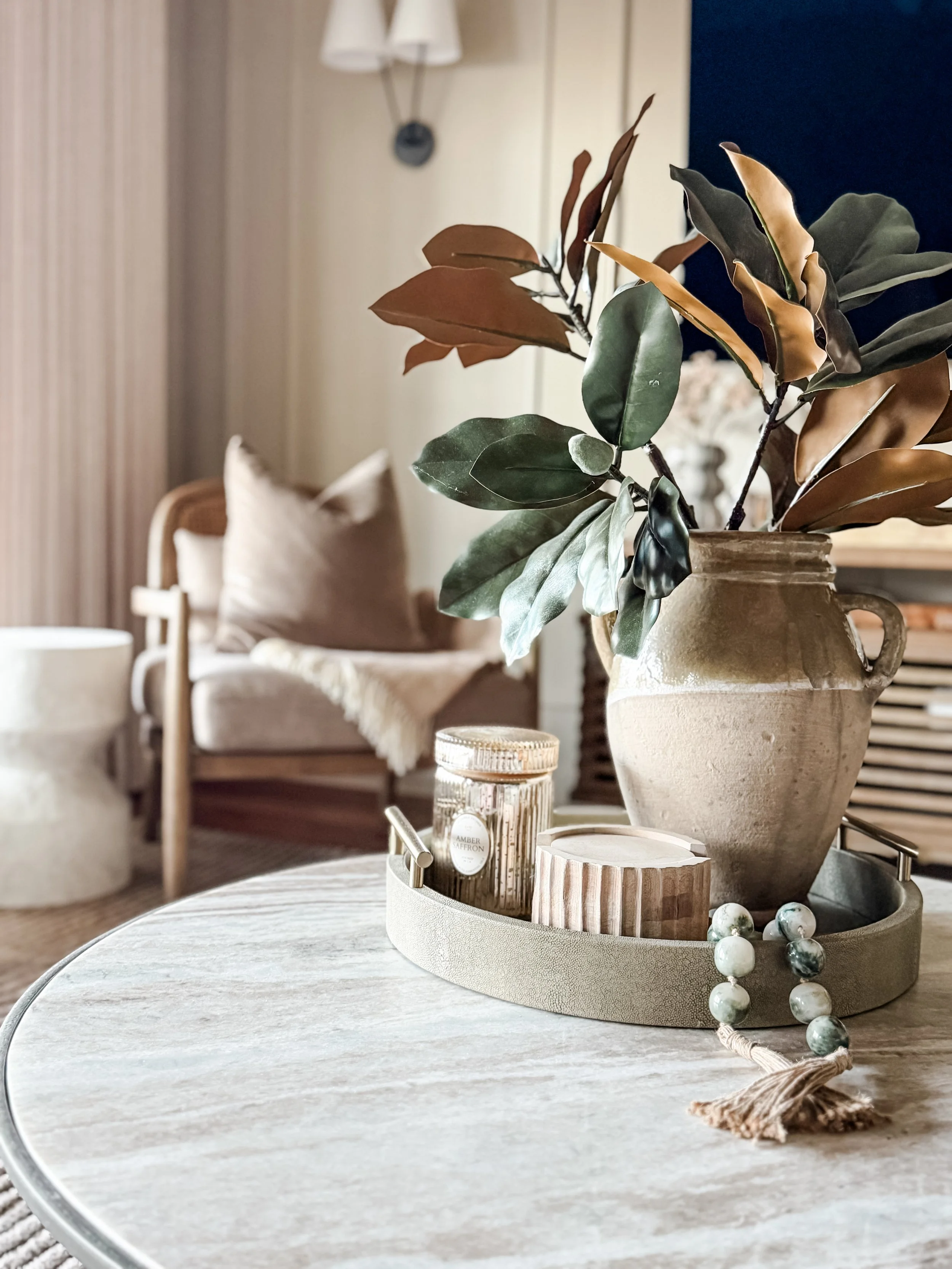 Neutral coffee table styling with organic materials in a thoughtfully designed living space by Studio Meadowv