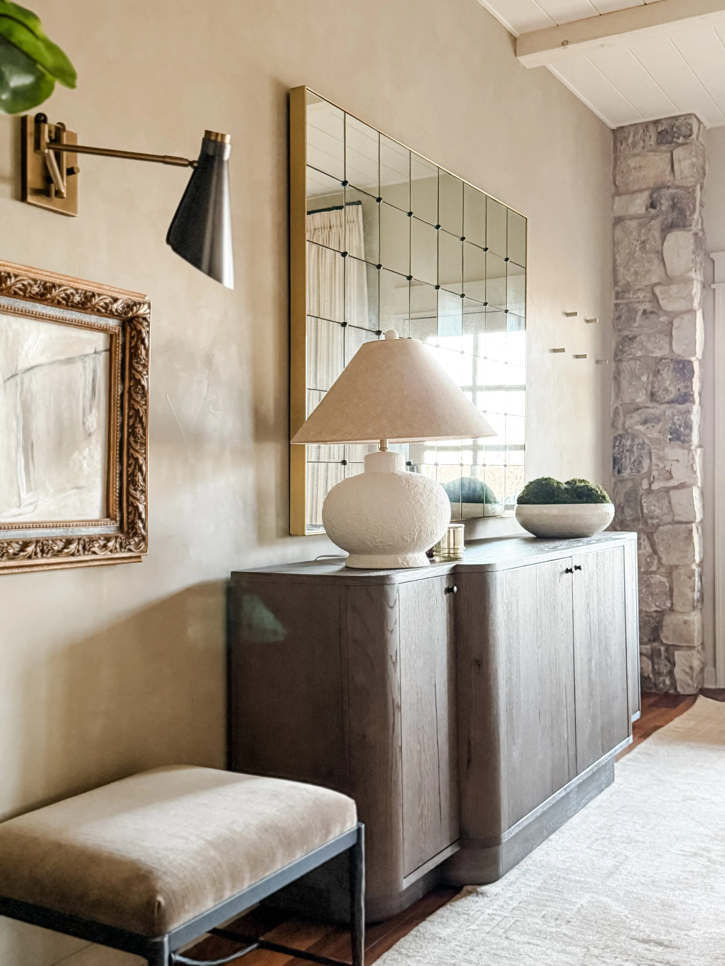 Antique mirror wall with layered console styling in a custom interior designed by Studio Meadow