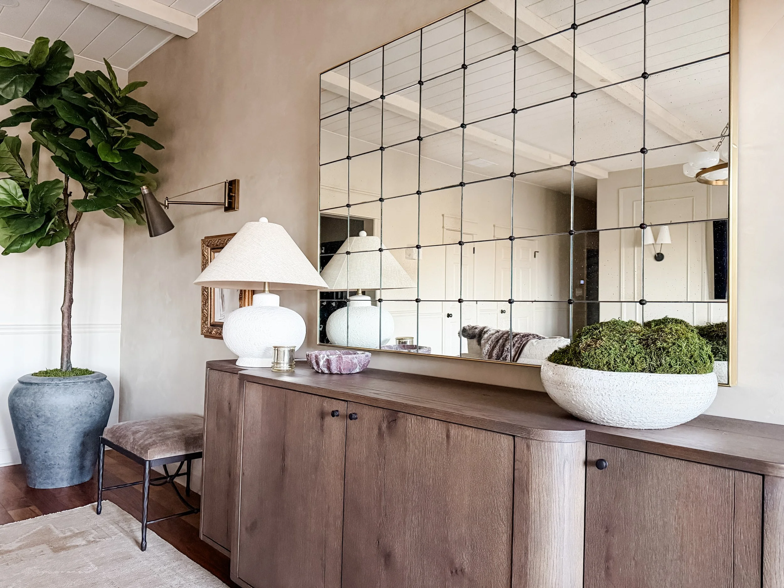 Styled console with antique mirror, soft lighting, and layered finishes in a Milton, Georgia home designed by Studio Meadow