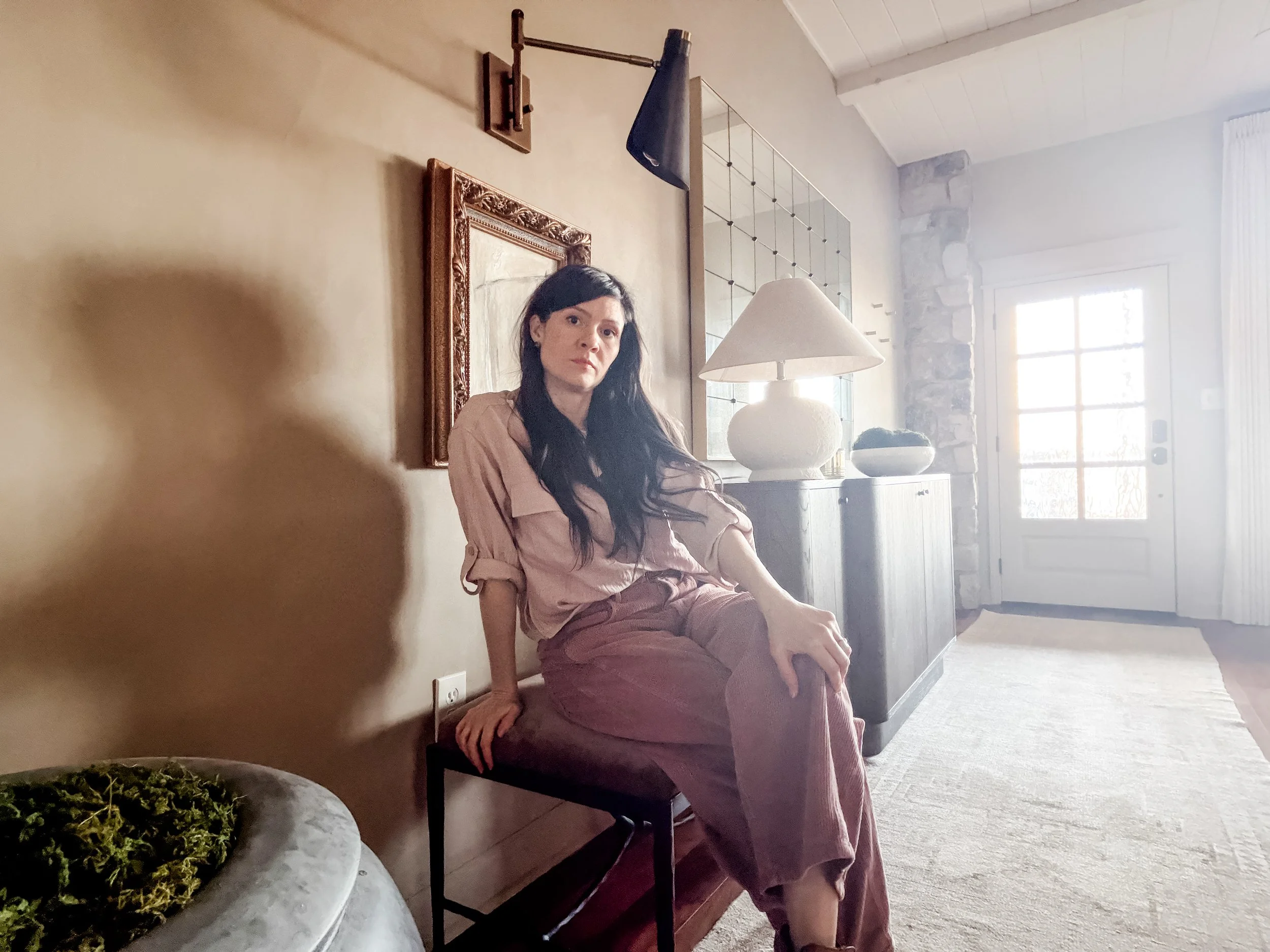 Interior designer Ashley Harrison in a layered living space designed through Studio Meadow