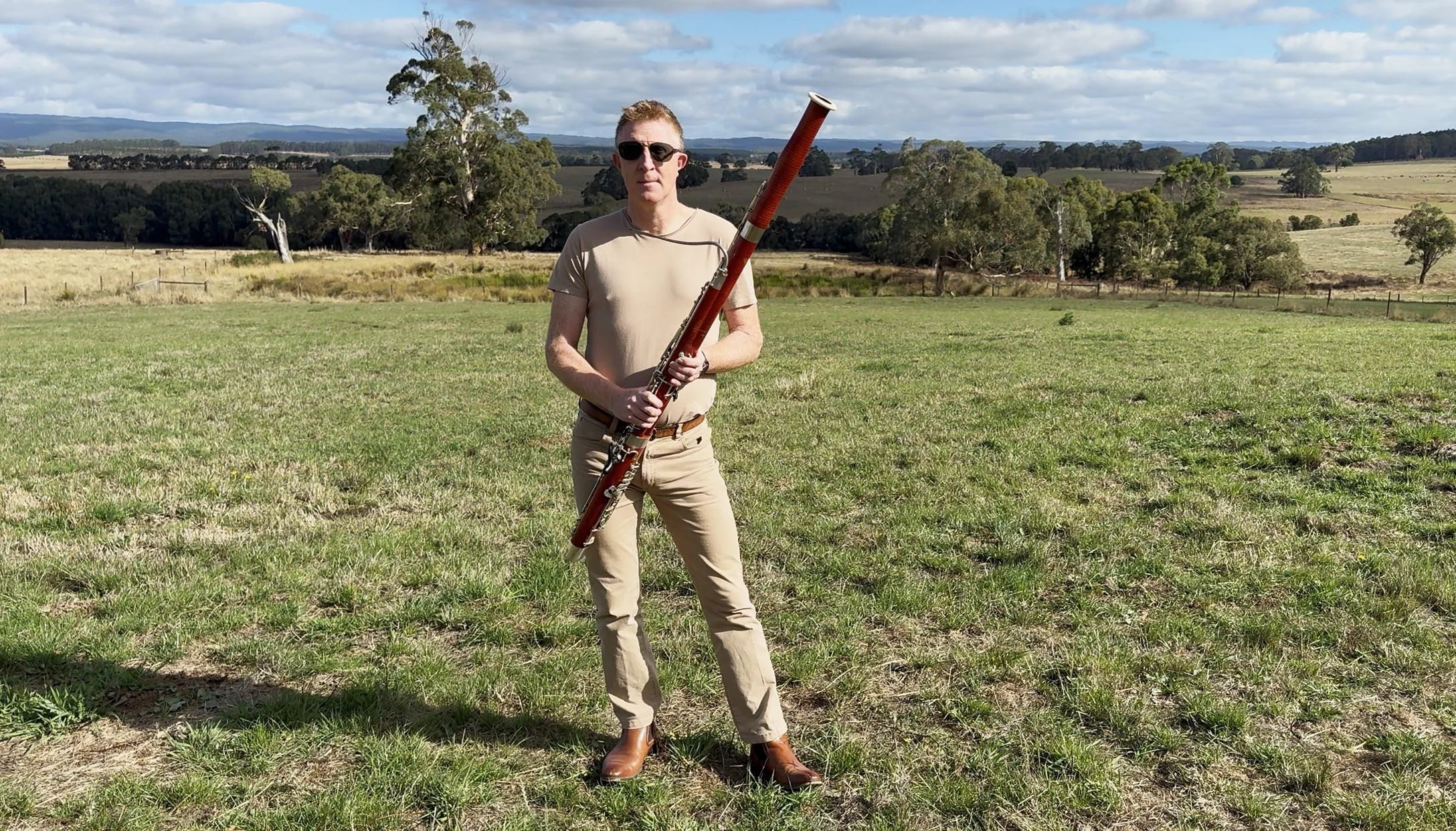 matthew standing in field with bassoon 1.jpg