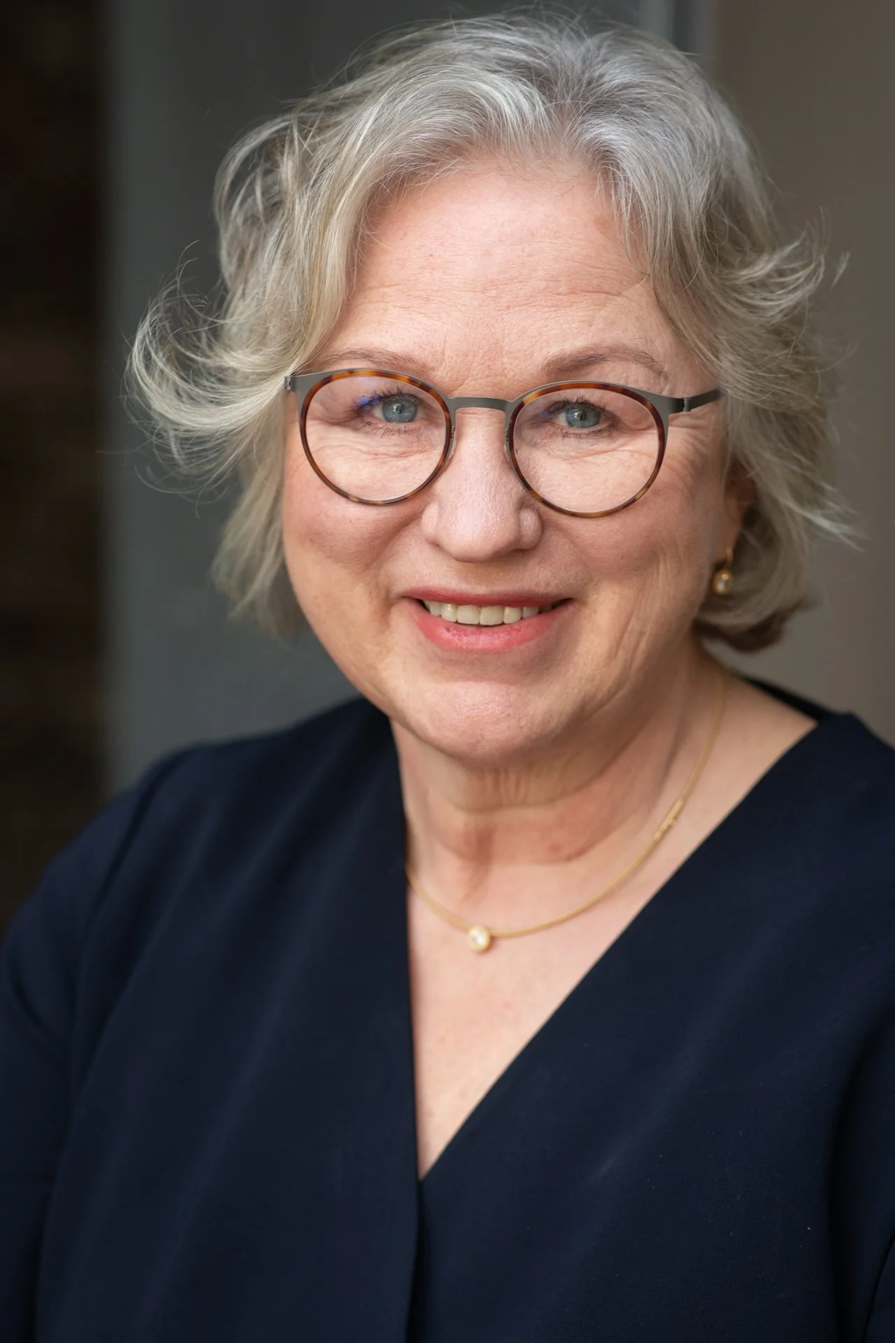 Dr. med. Henrike Schwarz, psychodynamische Business Coachin, freundliches Porträt vor neutralem Hintergrund
