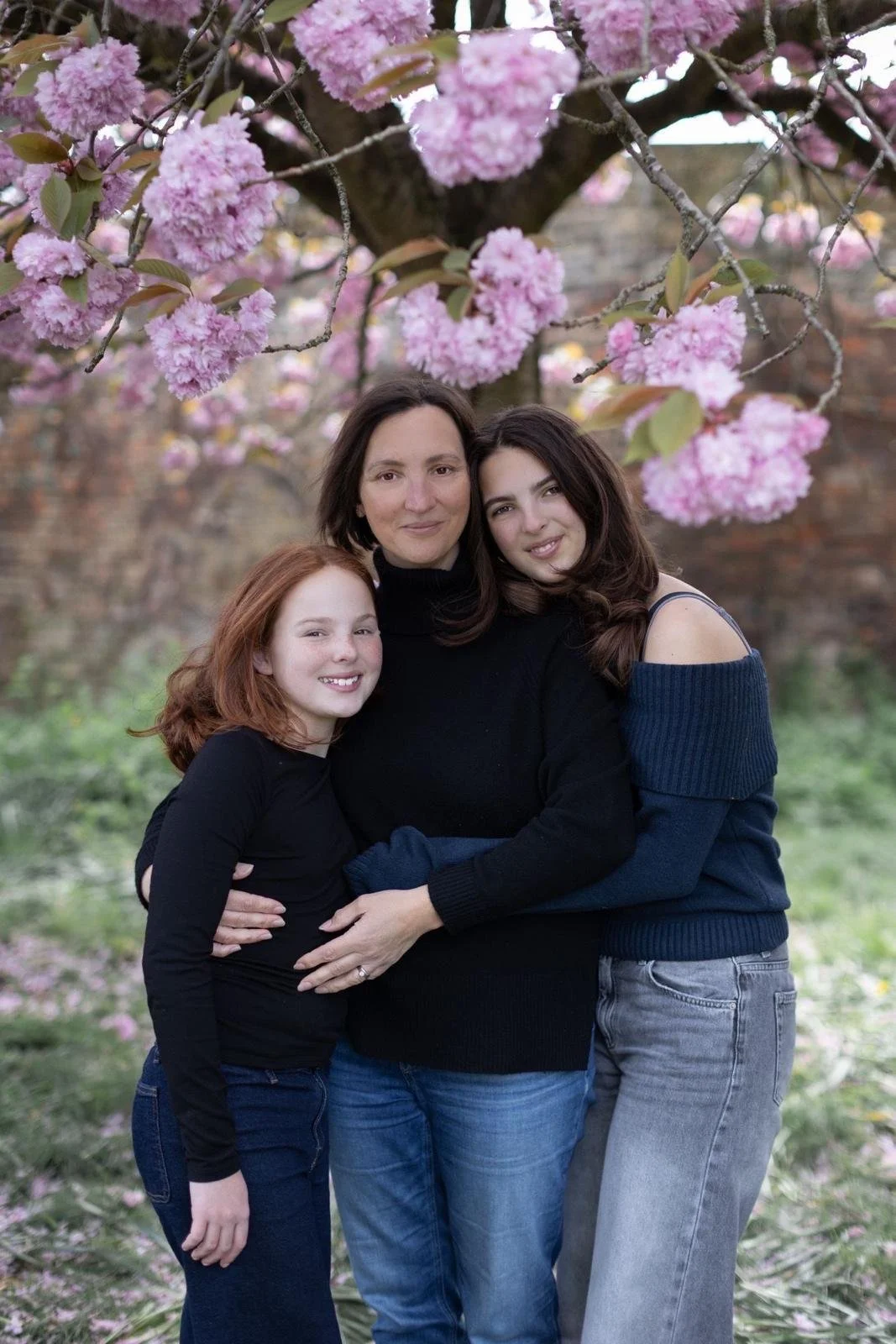 Mother and daughter under blossom tree