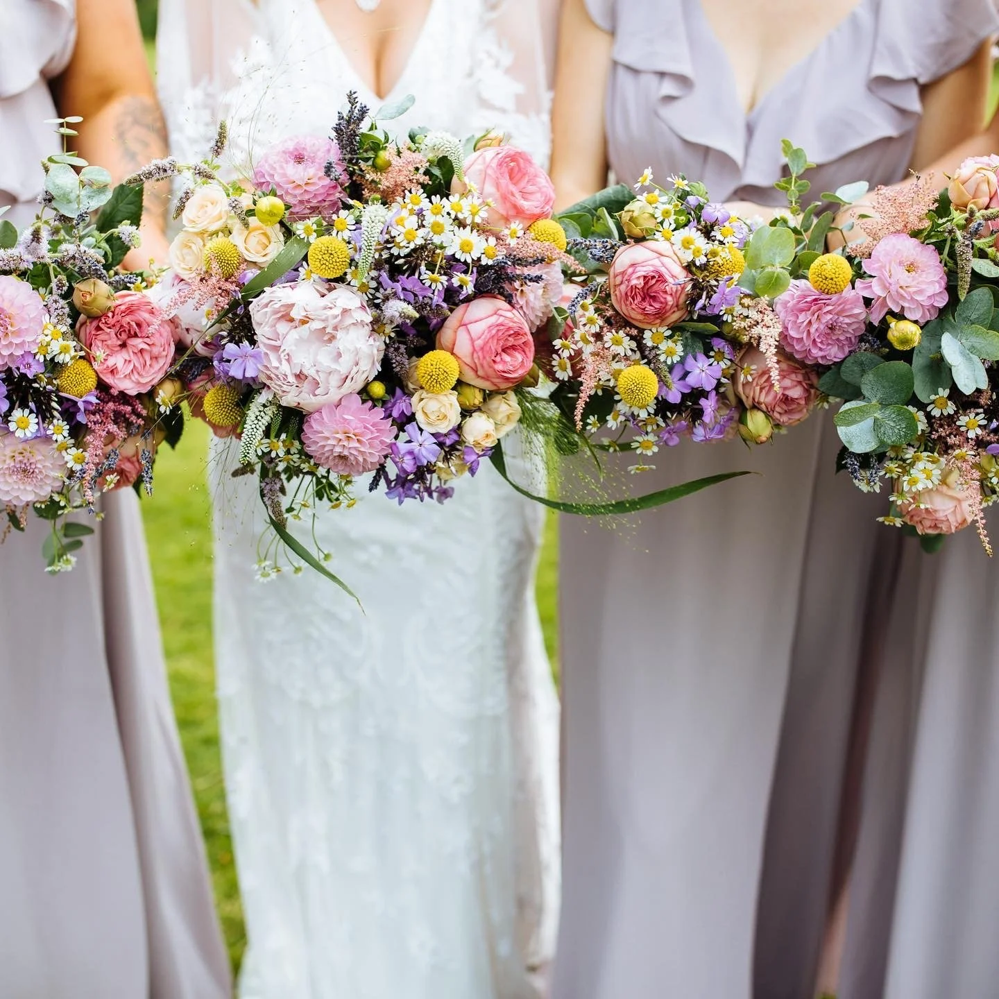 Kent bride with bridesmaids holding wildflower floral bouquets