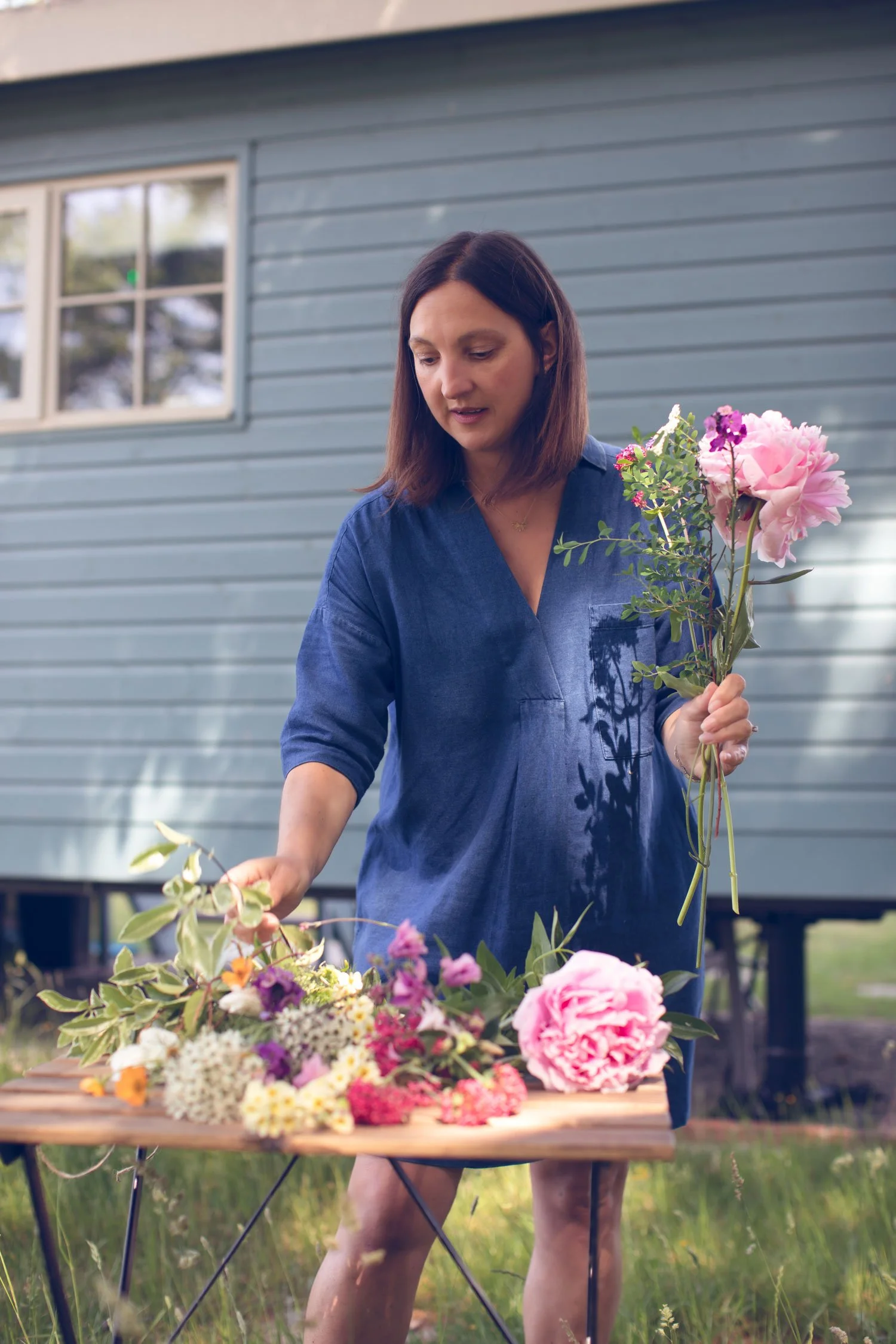 Kent and London based wedding florist arranging blooms in garden