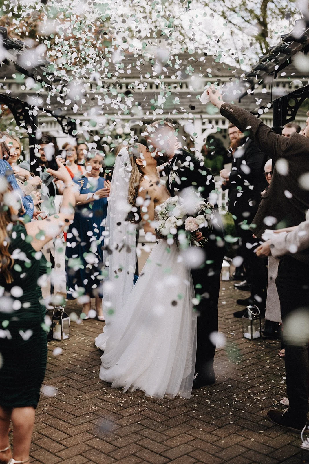 moody-blooms-wedding-confetti-exit-couple-white-bouquet-kent-florist.jpg