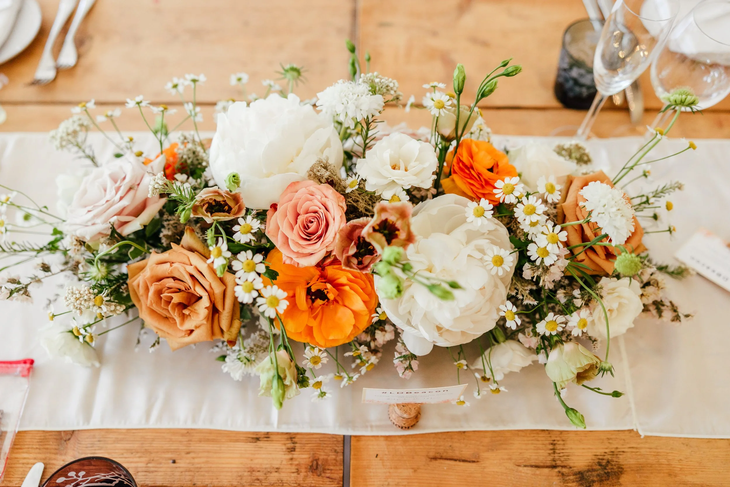 moody-blooms-wedding-flower-packages-table-centrepiece-orange-roses.jpg