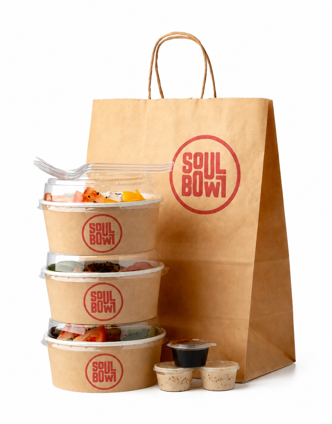 Stack of four takeout salad bowls with Soul Bowl logo, a large paper bag with Soul Bowl branding, and three small dipping containers with sauces. Soul Bowl food packaging for meal kits 