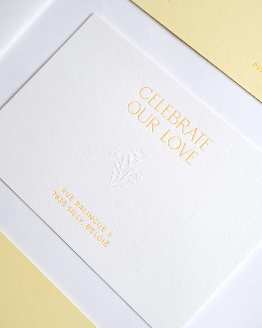 Letterpress wedding invitation with blind embossed flower detail