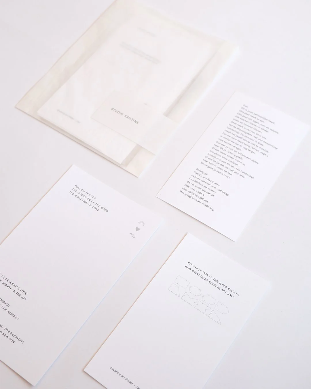 Architectural wedding stationery suite with folded elements and minimalist design.