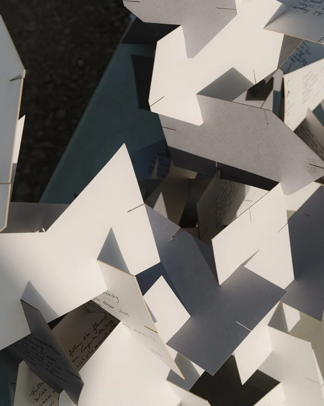 Architectural wedding stationery suite with folded elements and minimalist design.