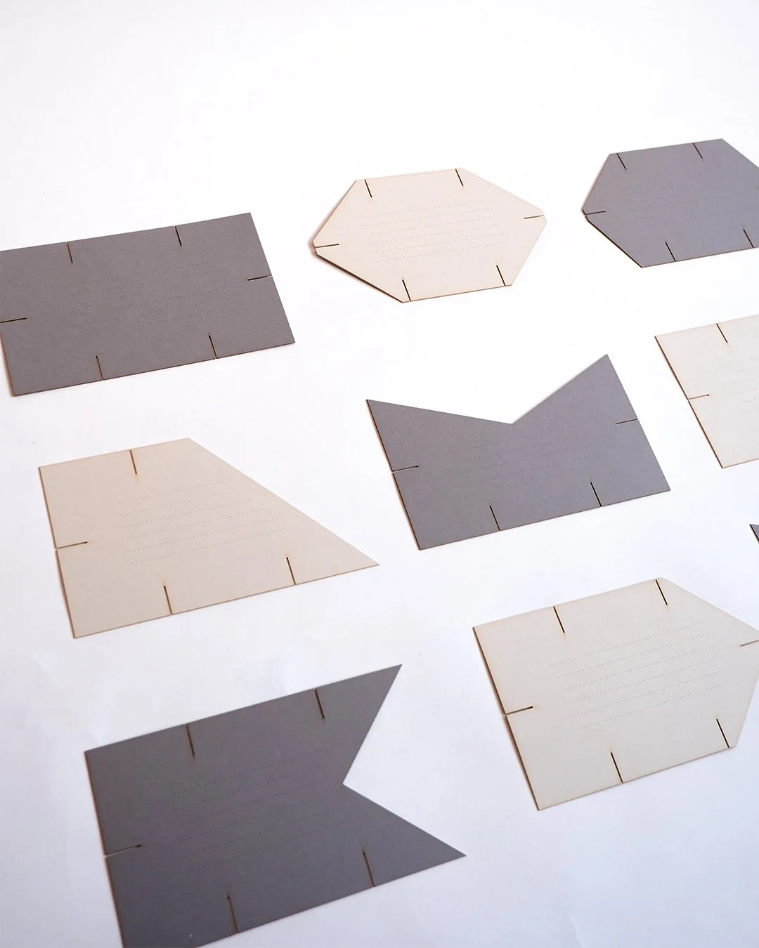 Architectural wedding stationery suite with folded elements and minimalist design.