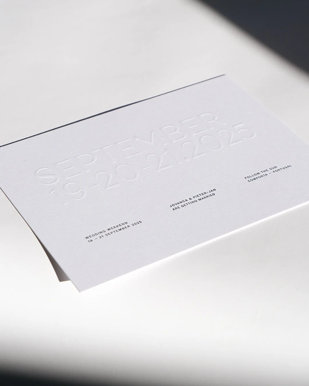 Architectural wedding stationery suite with folded elements and minimalist design.