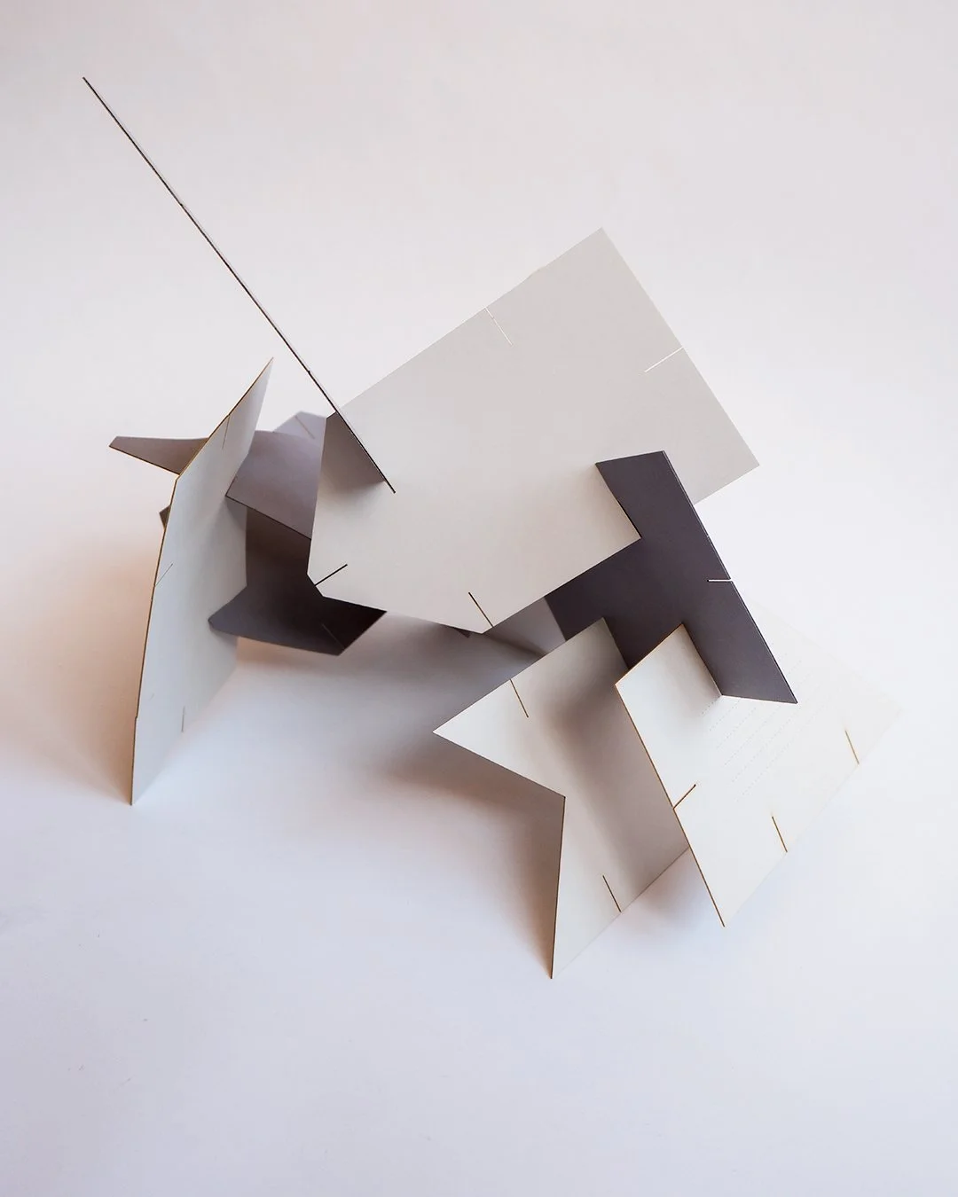 Architectural wedding stationery suite with folded elements and minimalist design.