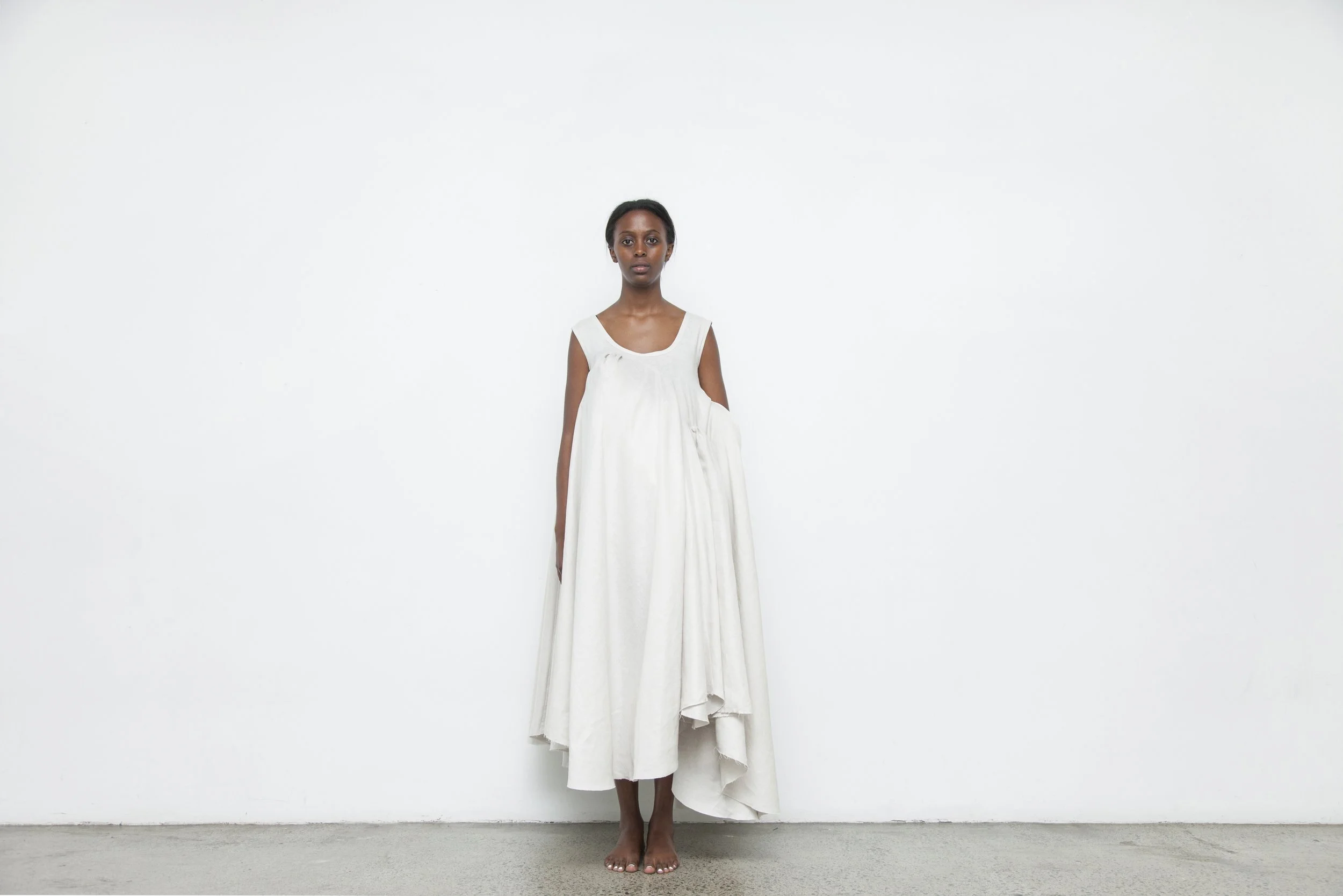 A striking coloured model wearing a 100% linen cubism-inspired Habit dress with sculptural geometric design, Auckland, New Zealand