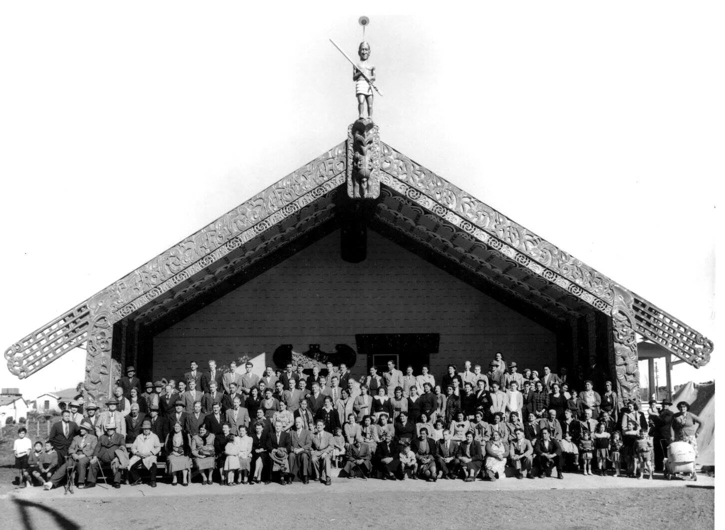 Historic image of Manutai marae, Rakaipaaka iwi with whānau gathered outside, honouring ancestors and reflecting Māori community, identity, and cultural connection.