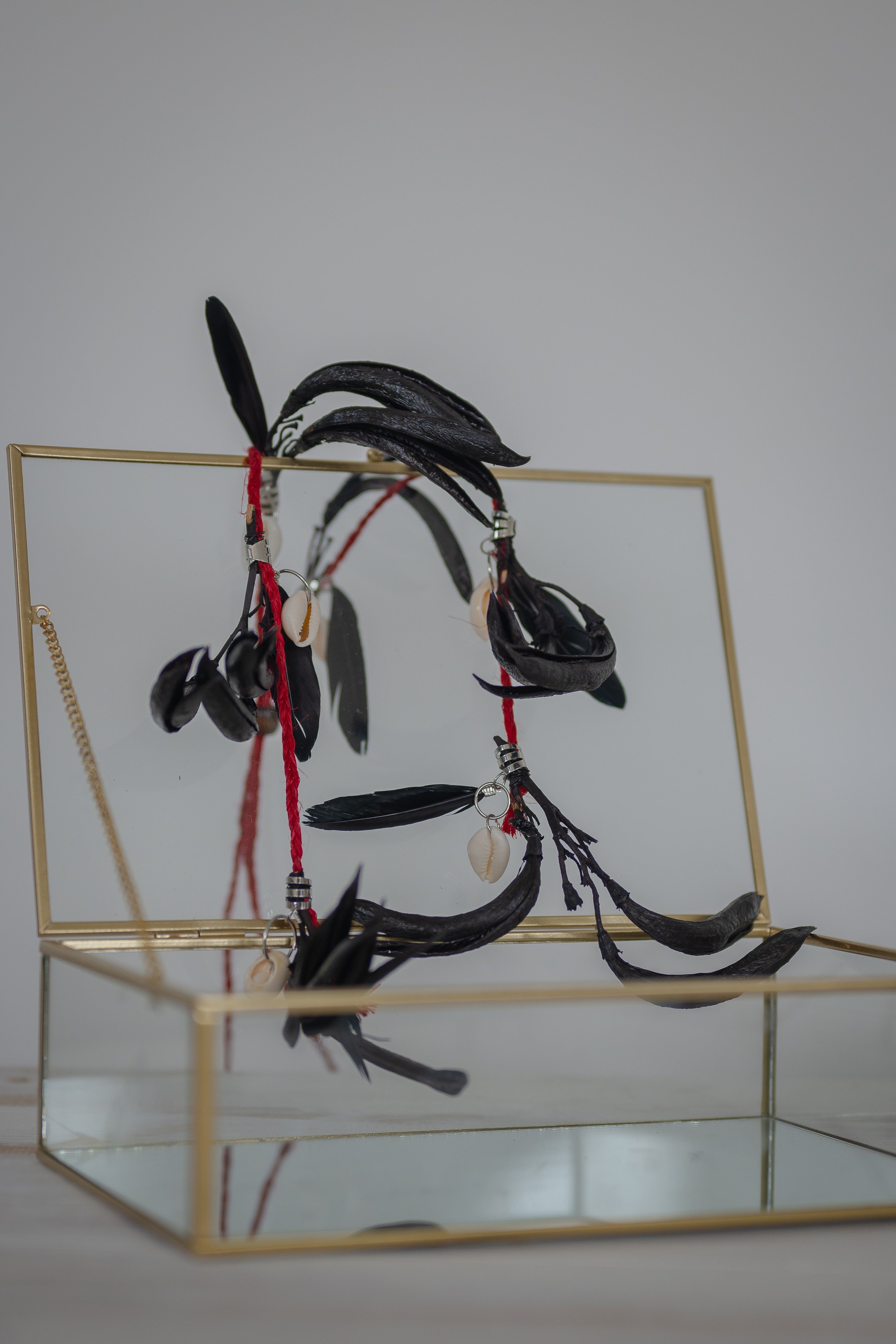 Harakeke flower and muka adornment on jewellery chest representing Māori taonga, cultural knowledge, and acknowledgement of knowledge holders.