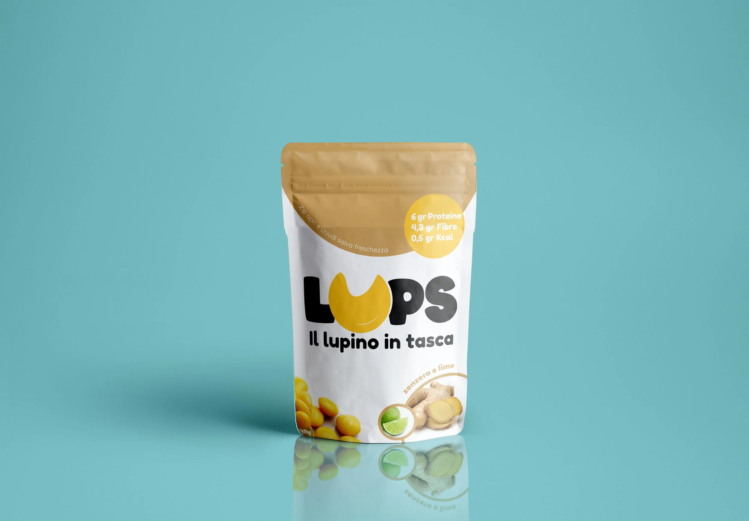 A food product package with a blue background. The package is mainly white with a brown top and yellow and green accents. Text on the package mentions 6 grams of protein, 4.3 grams of fiber, and 0.5 grams of calories. There are images of ginger, lime