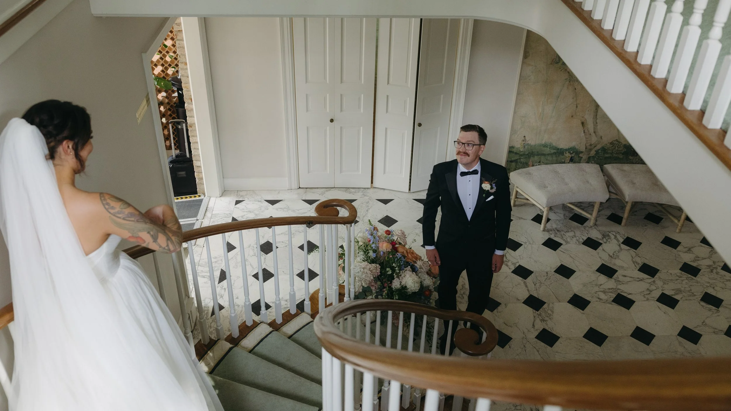 A bride and groom on a spiral staircase for their first look at a European inspired Lakewold Gardens wedding in Seattle