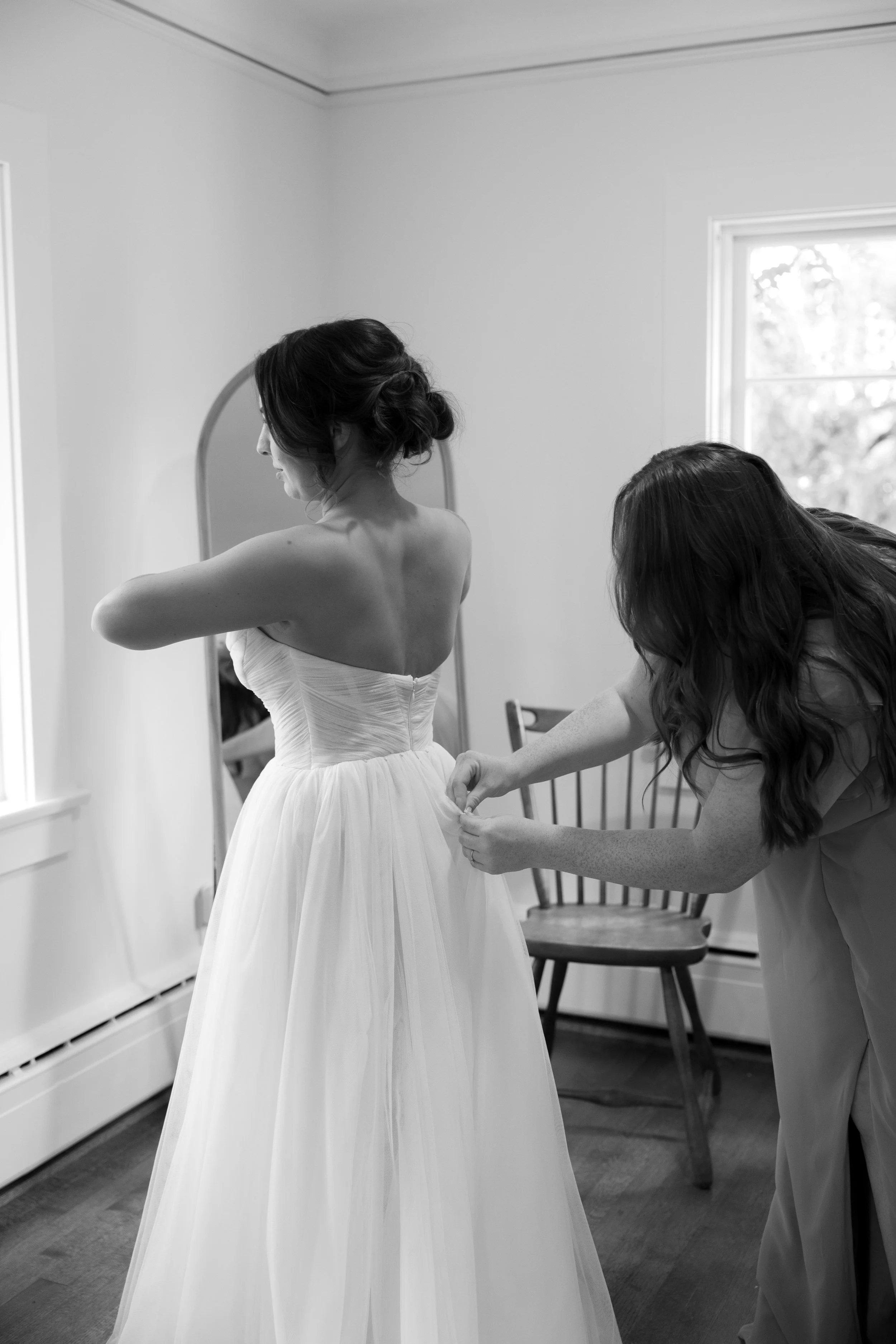 A bride getting into her dress at a European inspired Lakewold Gardens wedding in Seattle
